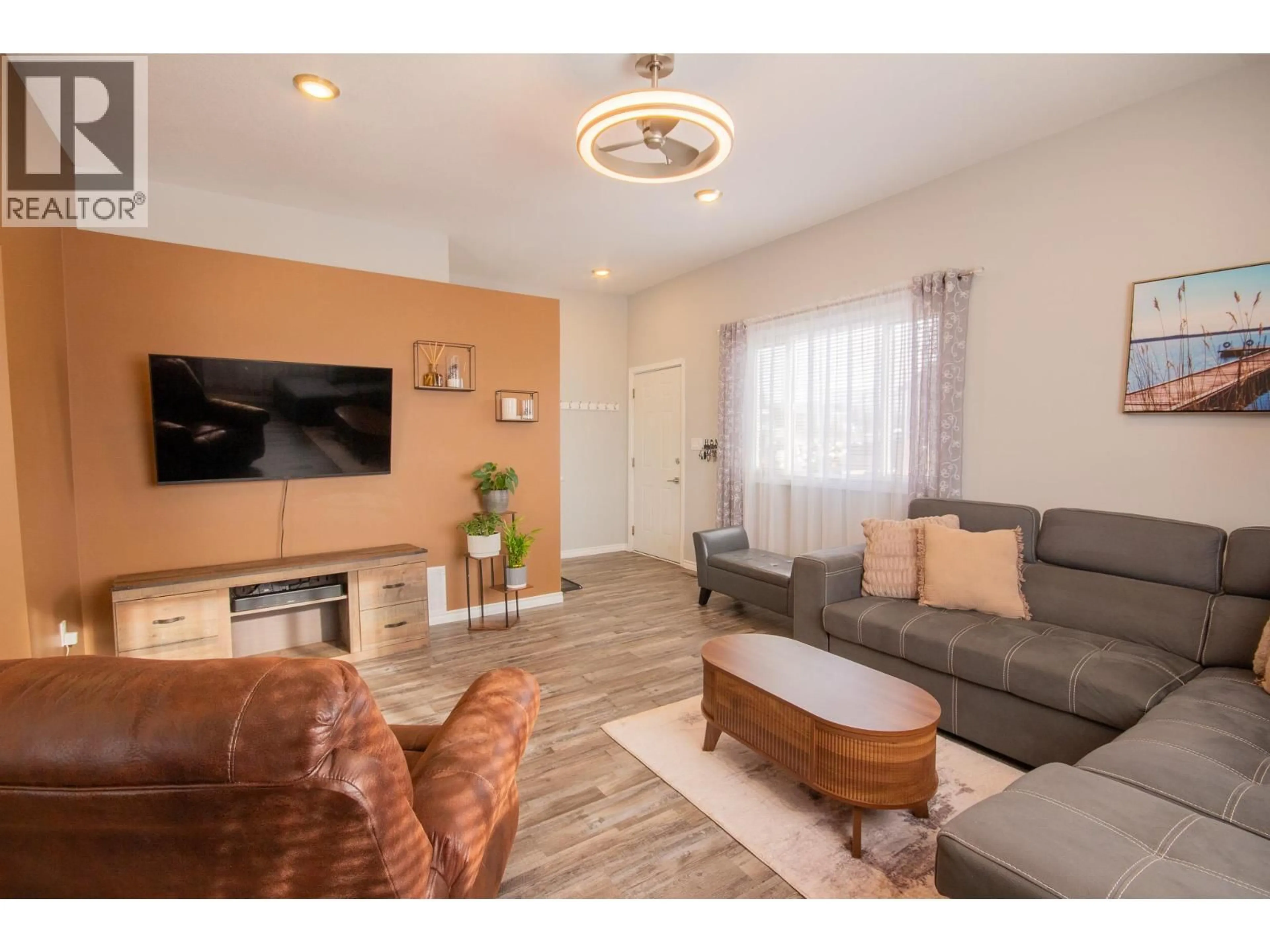 Living room with furniture, wood/laminate floor for 1500 96 AVENUE, Dawson Creek British Columbia V1G1L6