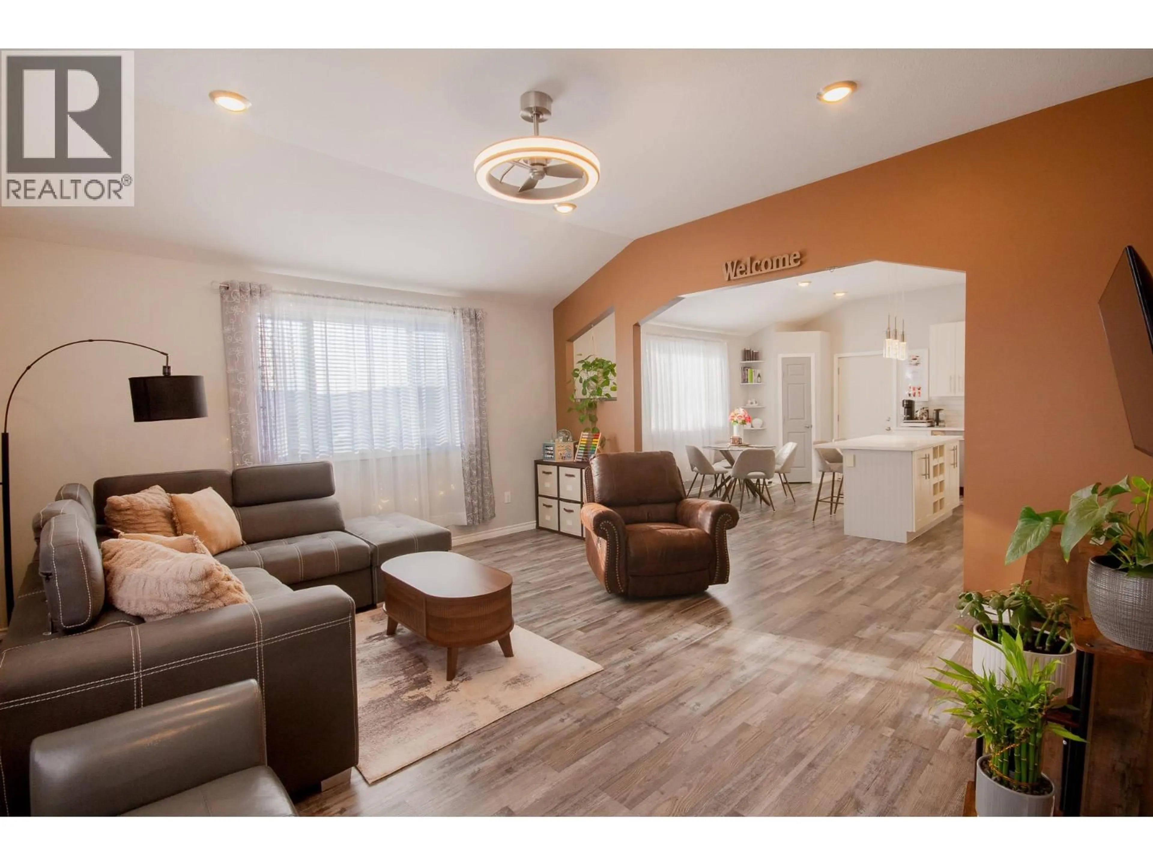 Living room with furniture, wood/laminate floor for 1500 96 AVENUE, Dawson Creek British Columbia V1G1L6