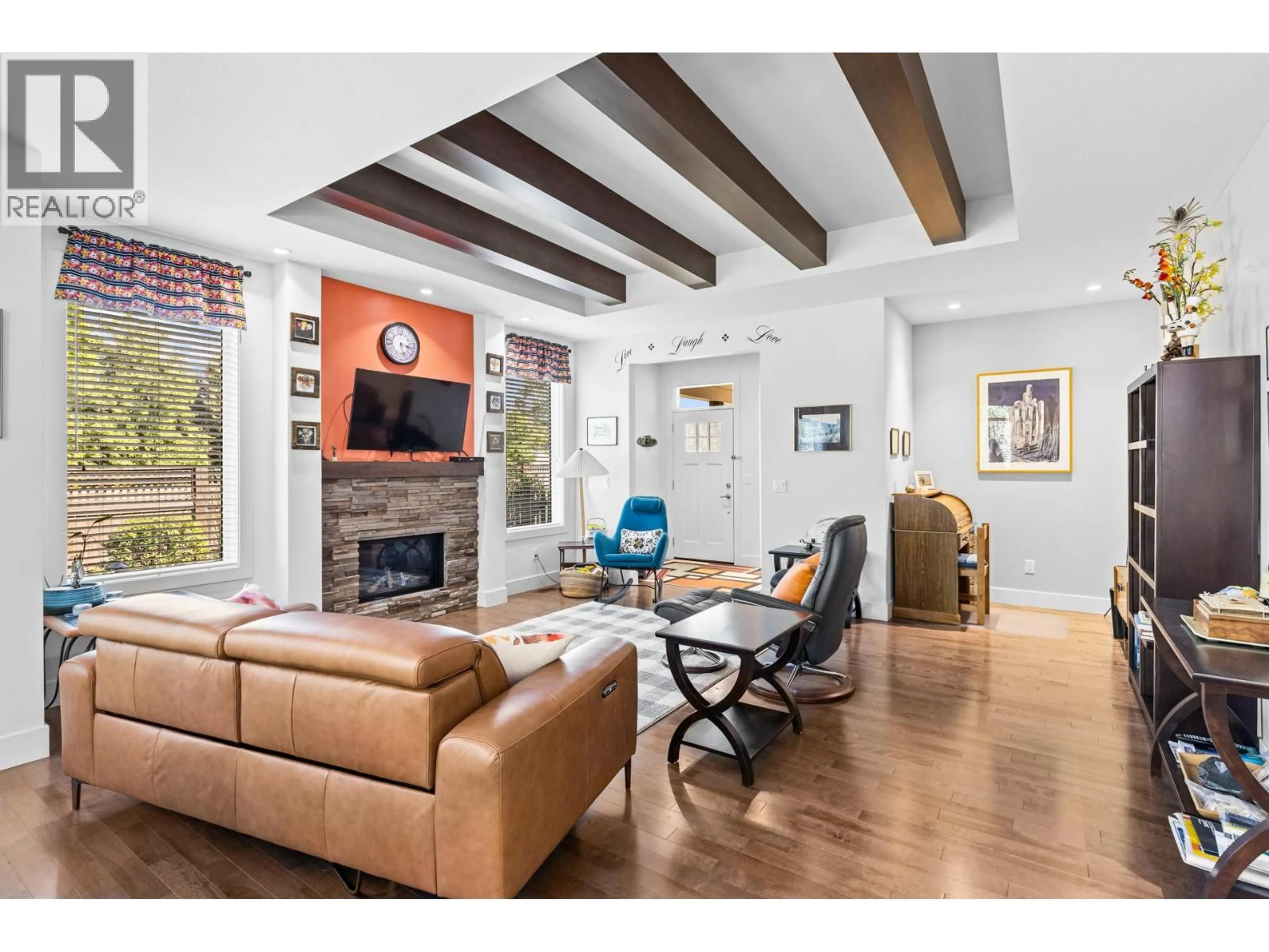Living room with furniture, wood/laminate floor for 50 - 1960 KLO ROAD, Kelowna British Columbia V1W5L2