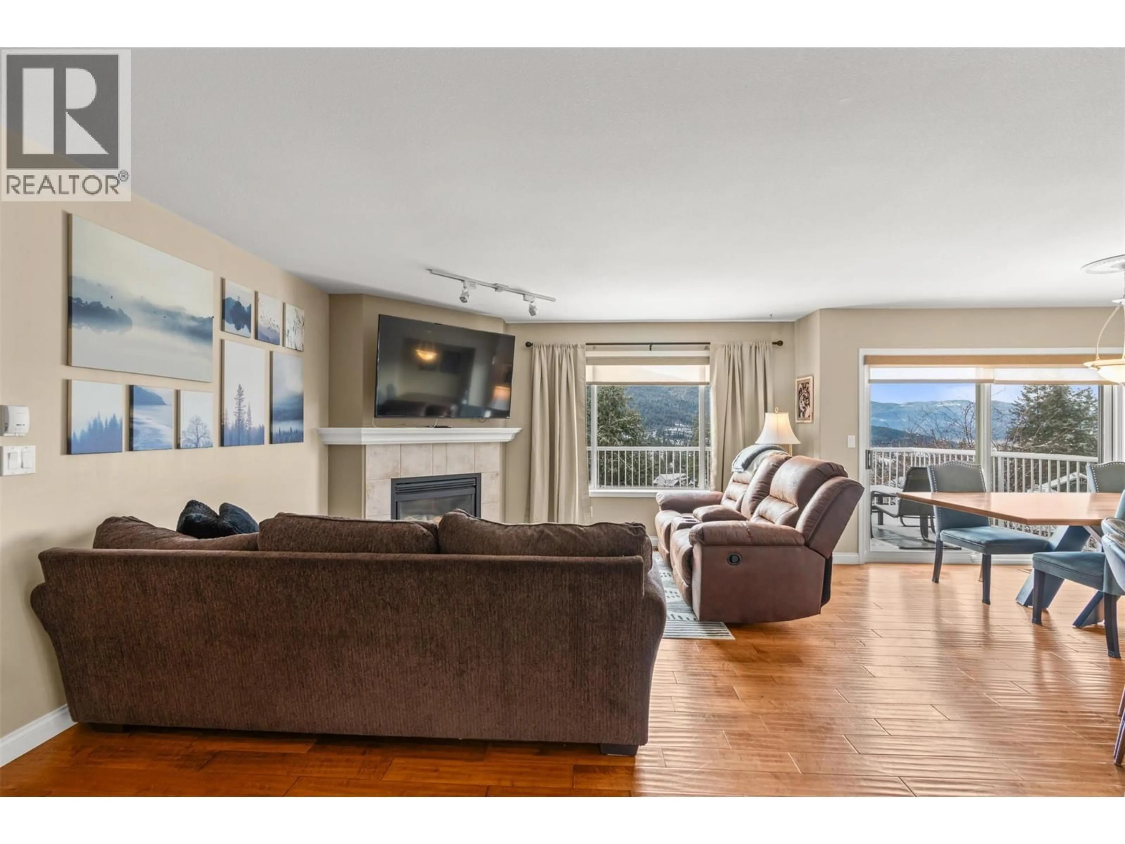 Living room with furniture, wood/laminate floor for 7044 NAKISKA DRIVE, Vernon British Columbia V1B3M5