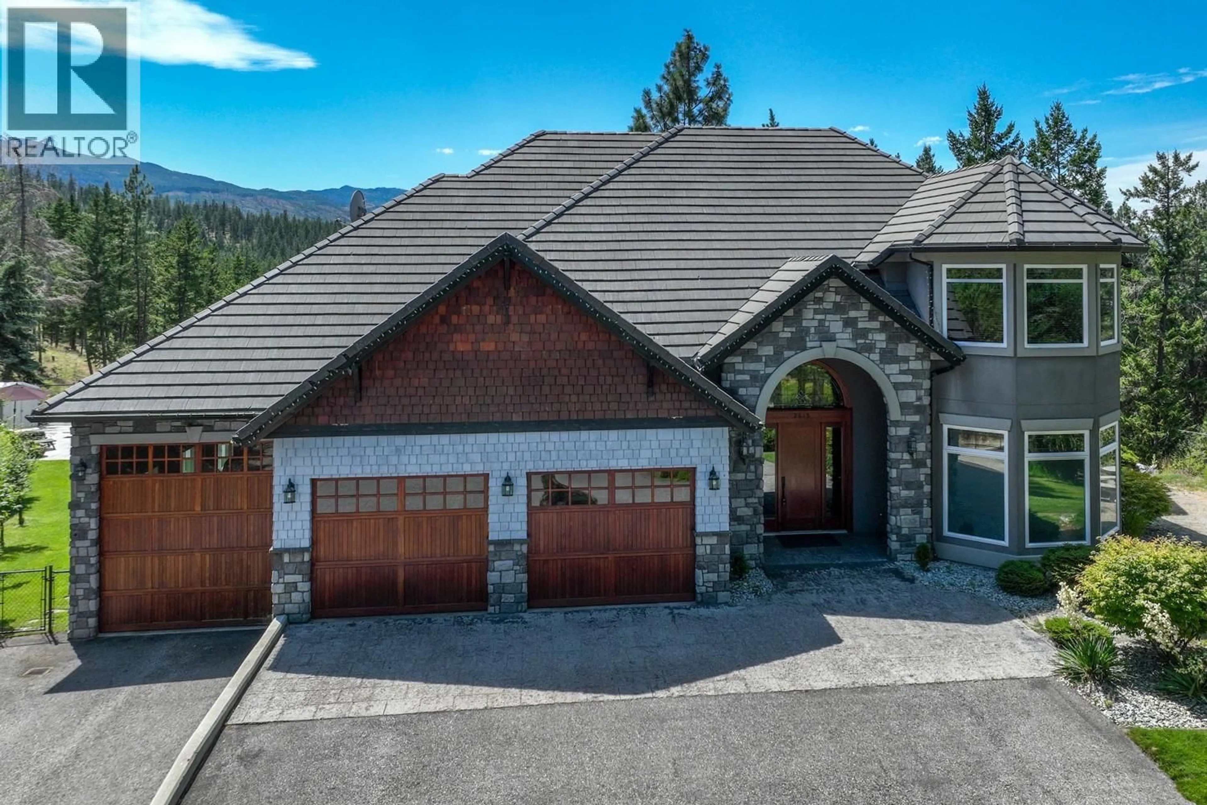 A pic from outside/outdoor area/front of a property/back of a property/a pic from drone, mountain view for 2615 HARVARD ROAD, Kelowna British Columbia V1W4C2