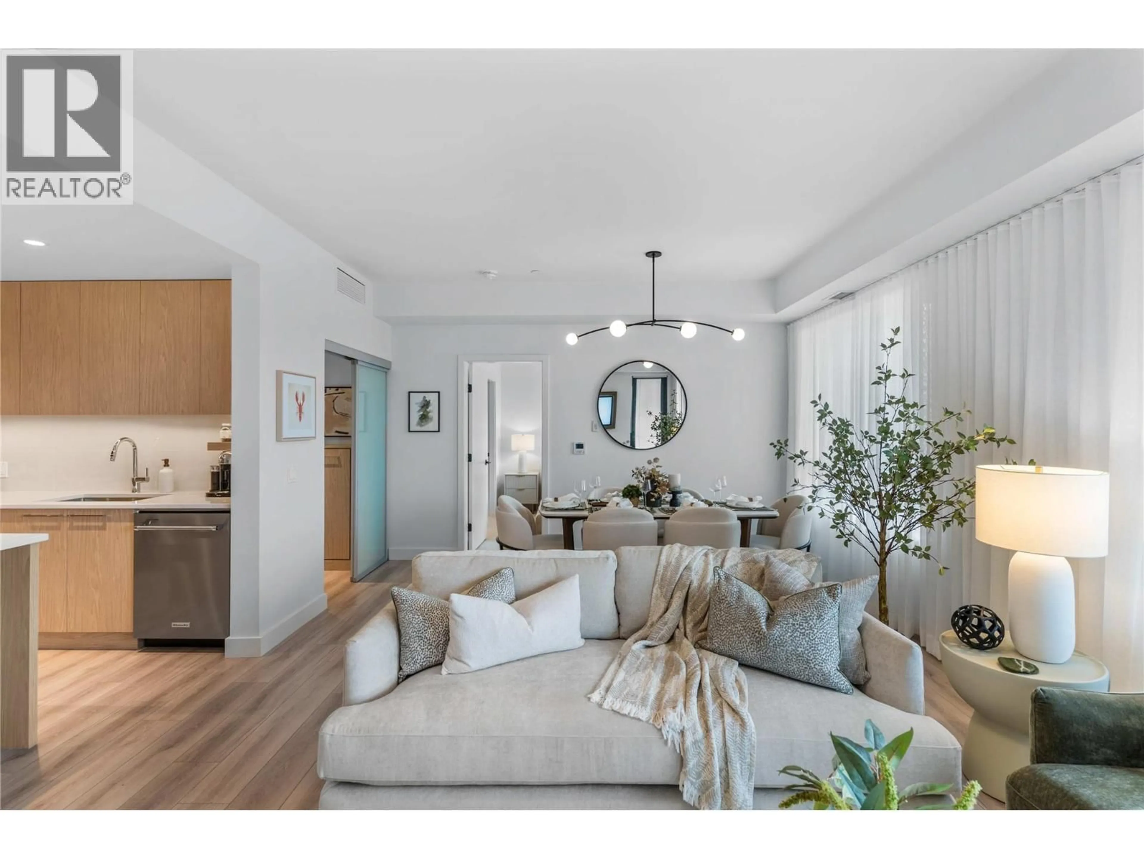 Living room with furniture, wood/laminate floor for 515 - 3051 ABBOTT STREET, Kelowna British Columbia V1Y0P1