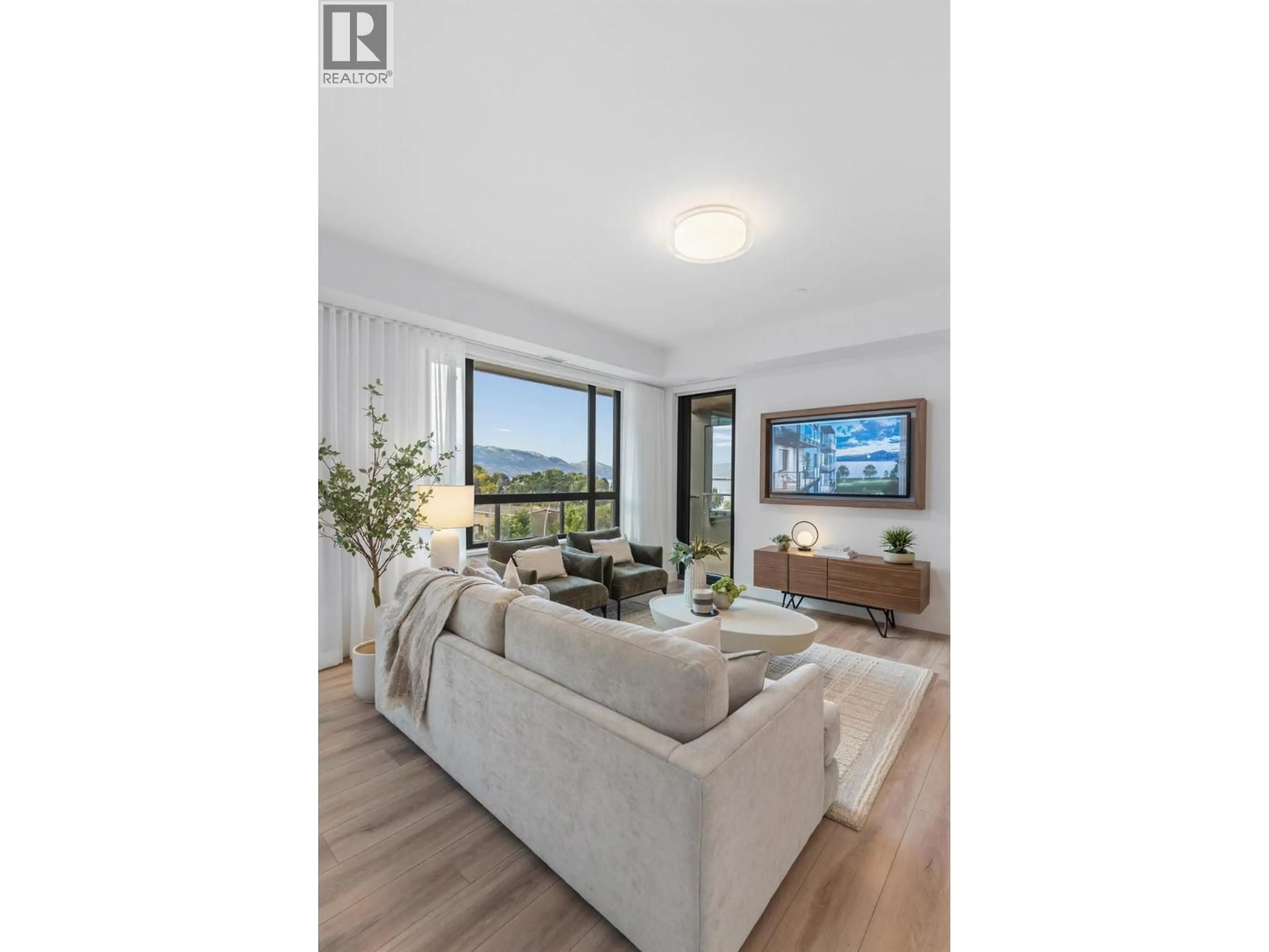 Living room with furniture, wood/laminate floor for 515 - 3051 ABBOTT STREET, Kelowna British Columbia V1Y0P1