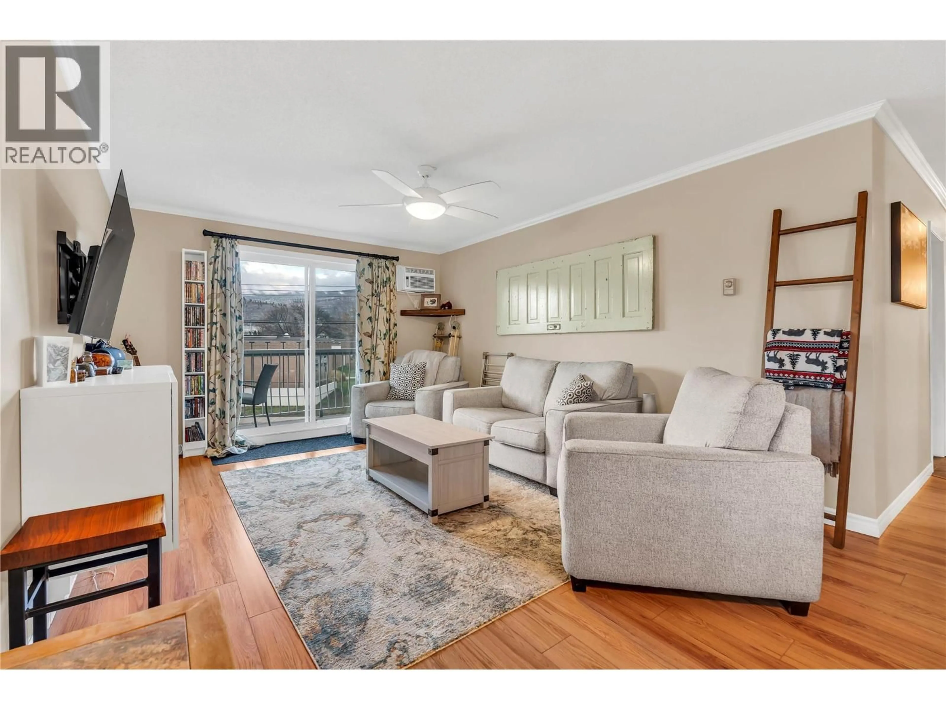 Living room with furniture, wood/laminate floor for 312 - 803 FAIRVIEW ROAD, Penticton British Columbia V2A5Y7