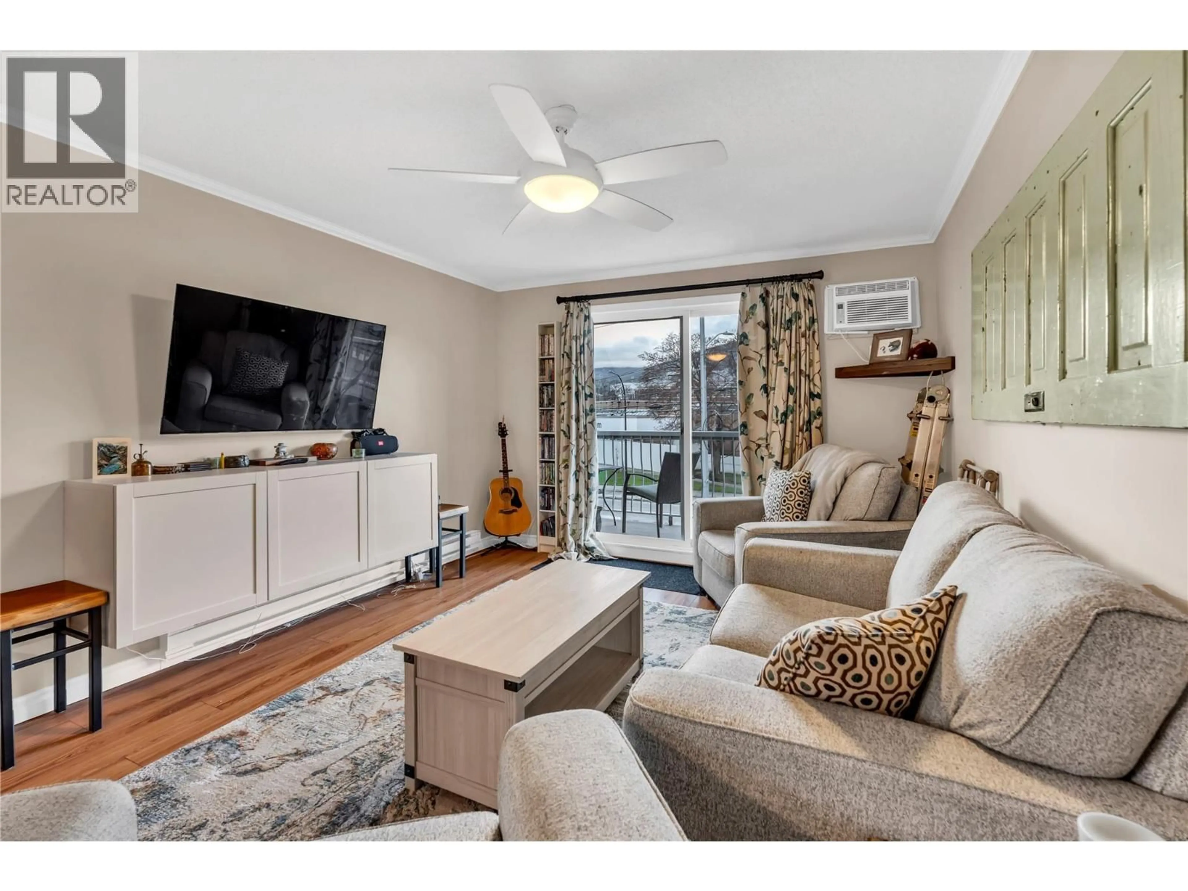 Living room with furniture, wood/laminate floor for 312 - 803 FAIRVIEW ROAD, Penticton British Columbia V2A5Y7