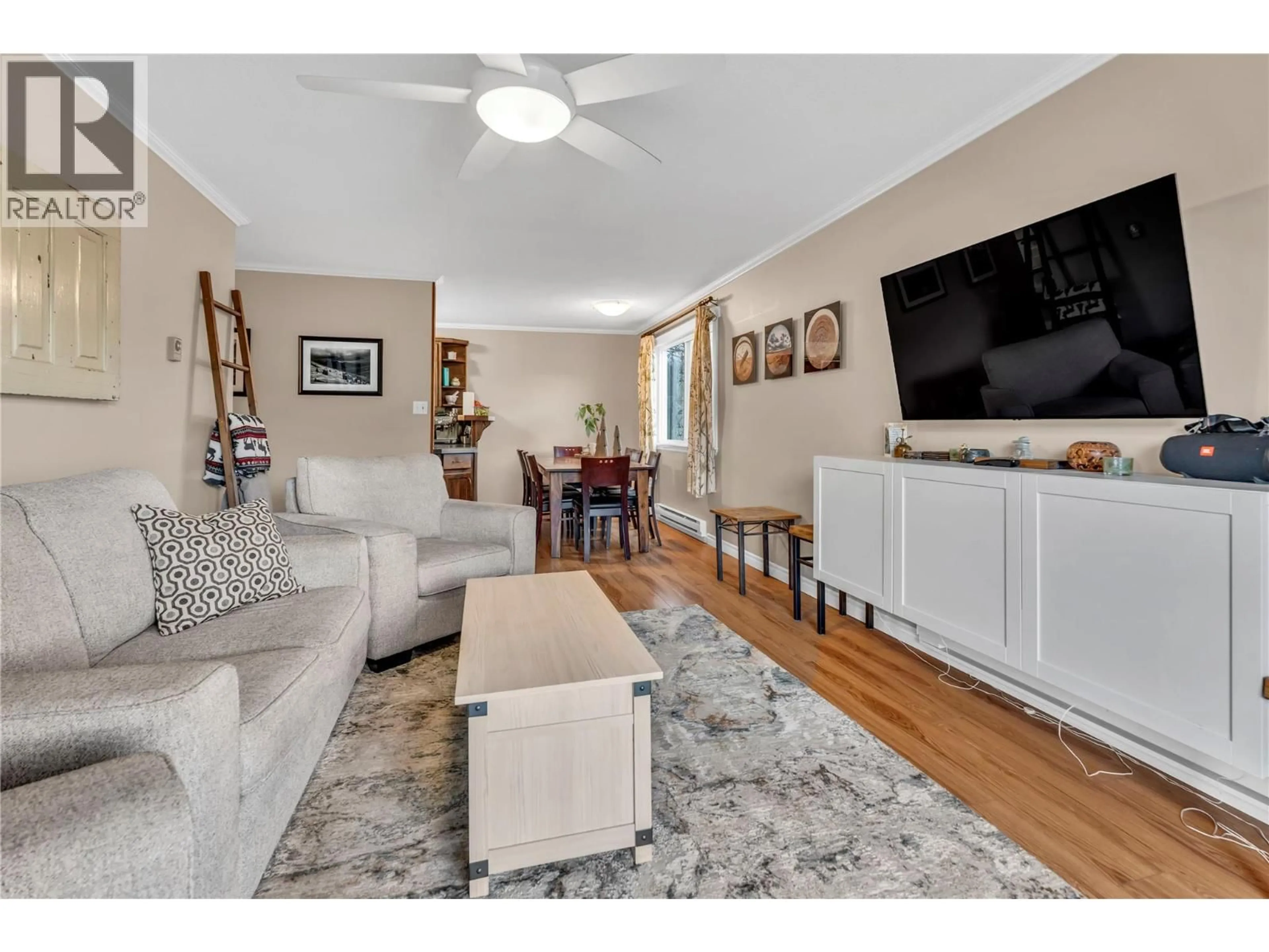 Living room with furniture, wood/laminate floor for 312 - 803 FAIRVIEW ROAD, Penticton British Columbia V2A5Y7