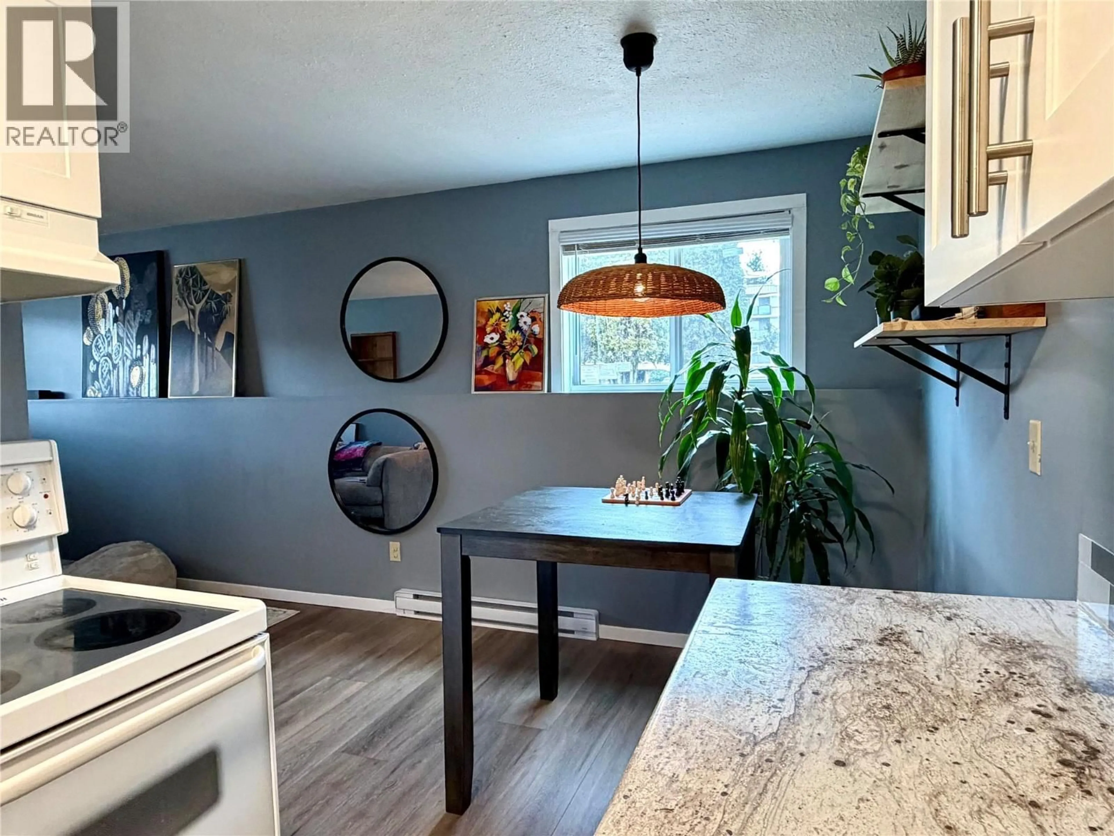 Open concept kitchen, wood/laminate floor for 111 - 150 SKAHA PLACE, Penticton British Columbia V2A7K1