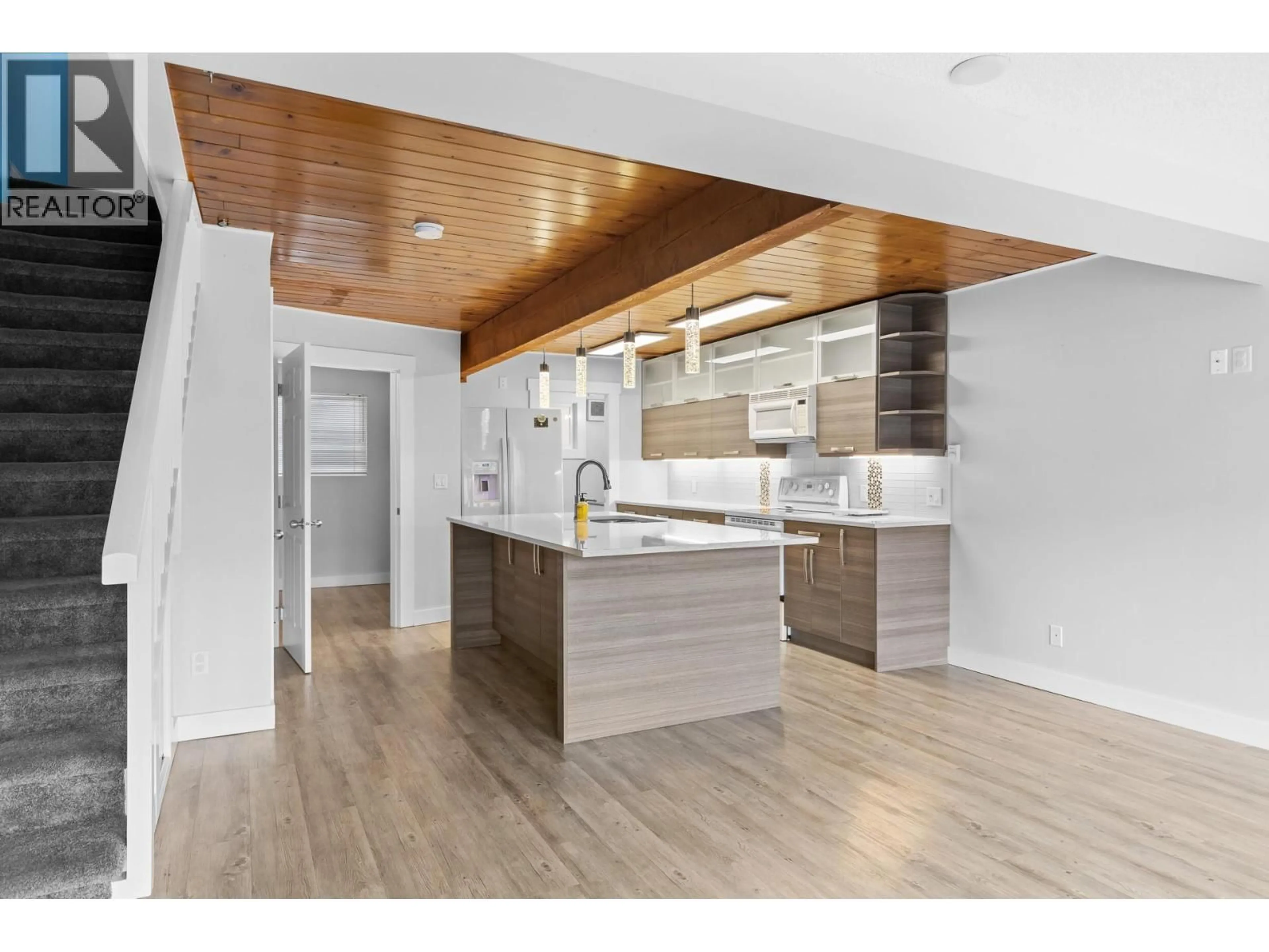 Open concept kitchen, wood/laminate floor for 2 - 7779 OKANAGAN LANDING ROAD, Vernon British Columbia V1H1L4