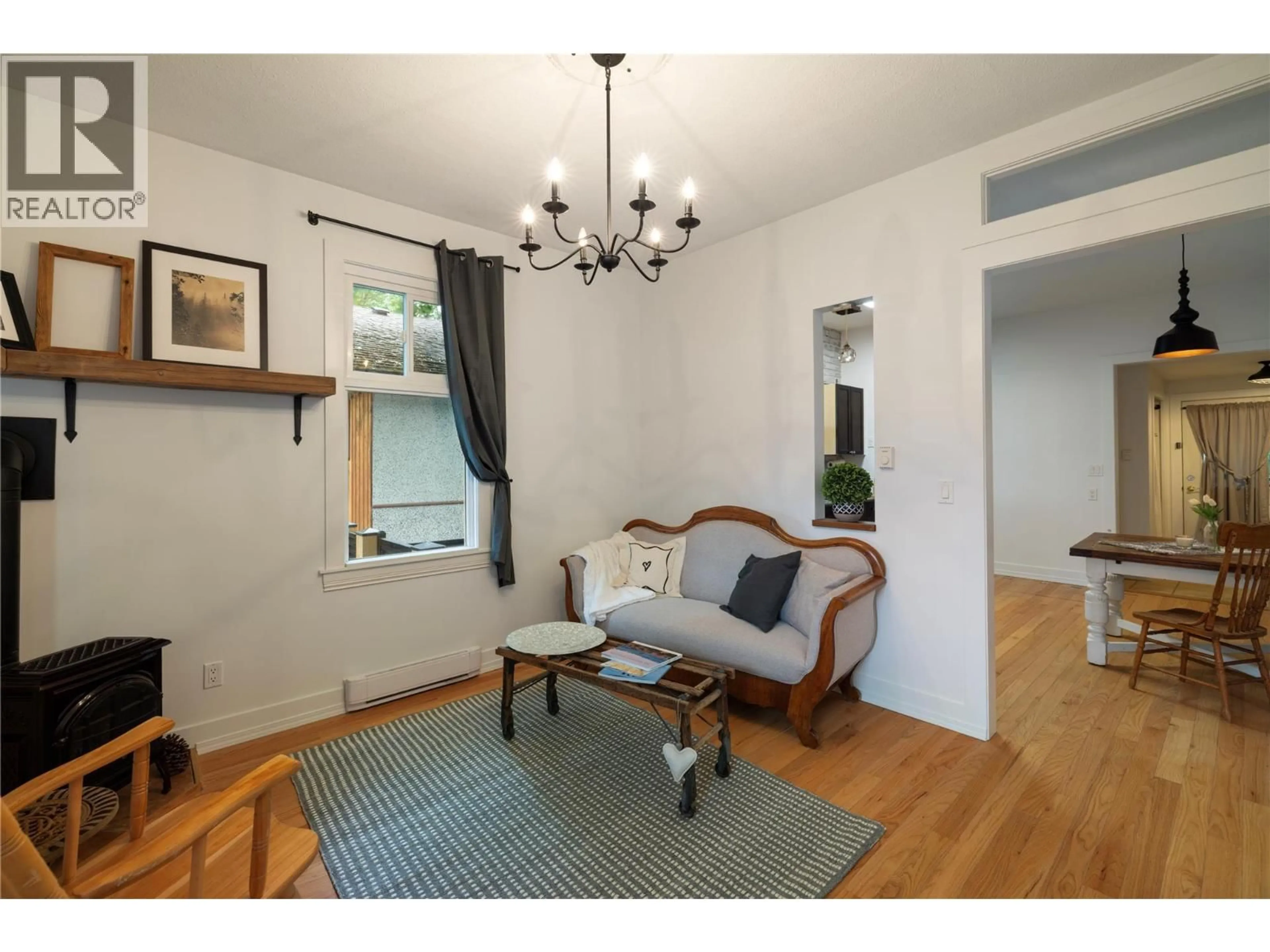 Living room with furniture, wood/laminate floor for 3408 34 AVENUE, Vernon British Columbia V1T2P9