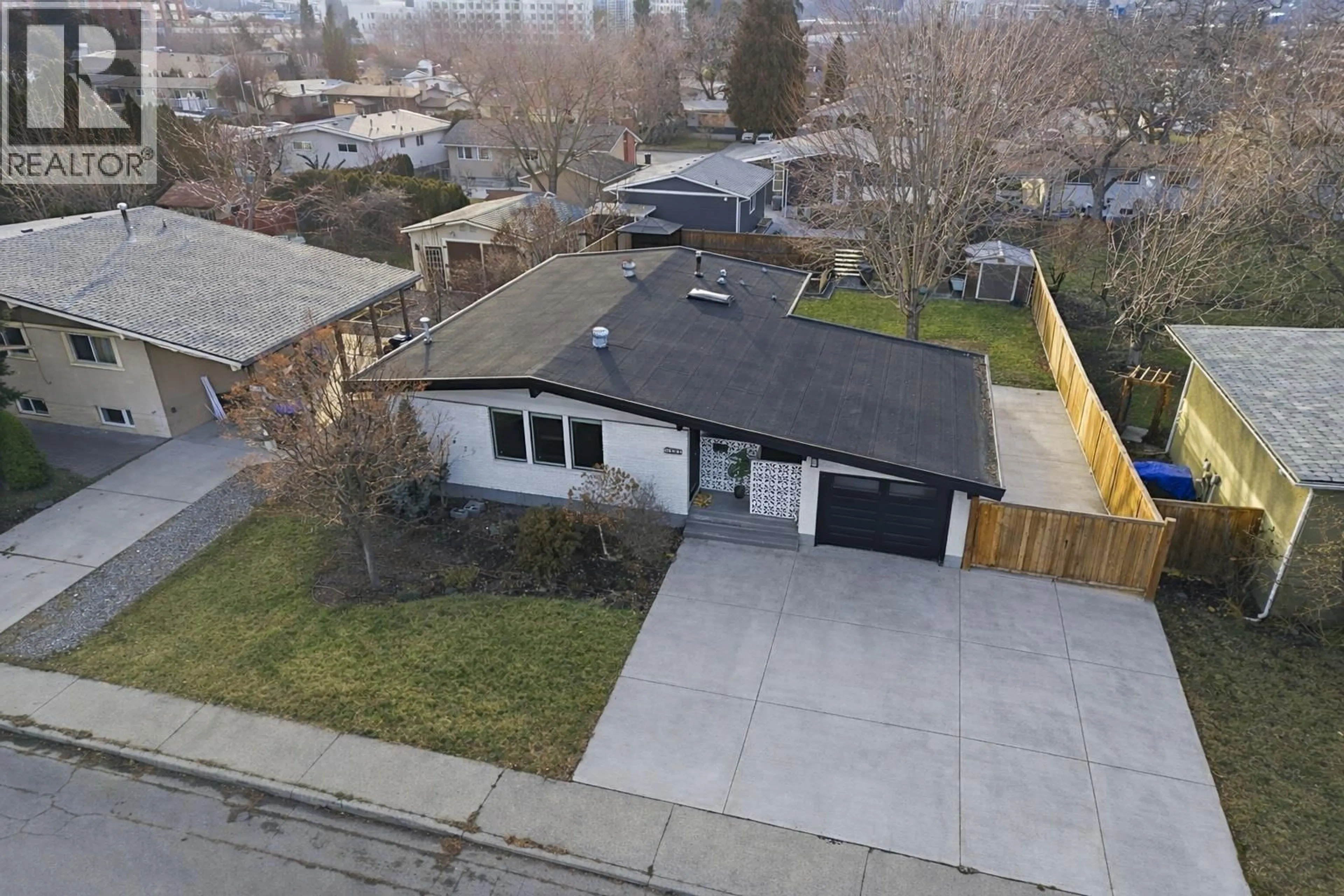 A pic from outside/outdoor area/front of a property/back of a property/a pic from drone, street for 1497 LOMBARDY SQUARE, Kelowna British Columbia V1Y3S6