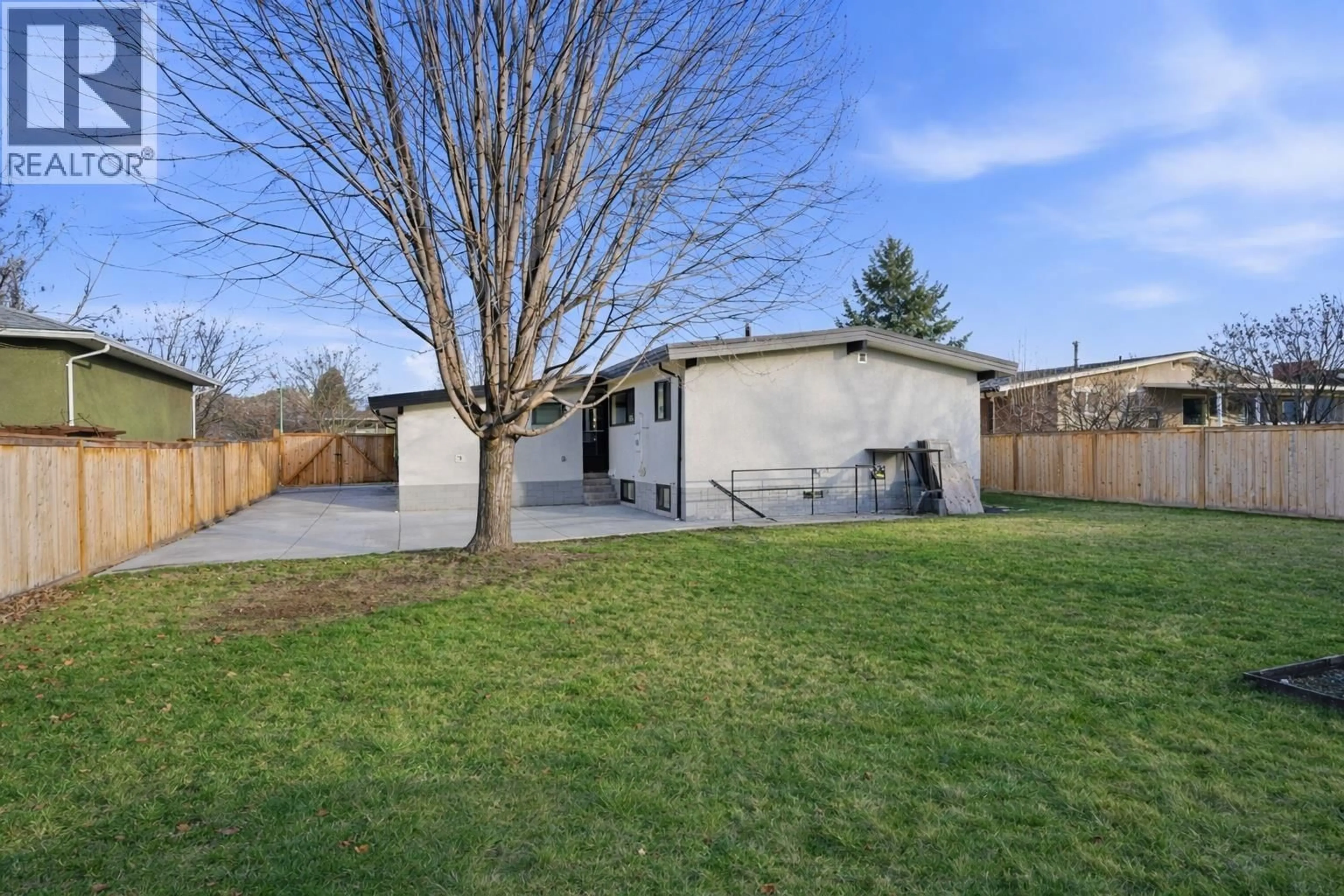 A pic from outside/outdoor area/front of a property/back of a property/a pic from drone, street for 1497 LOMBARDY SQUARE, Kelowna British Columbia V1Y3S6