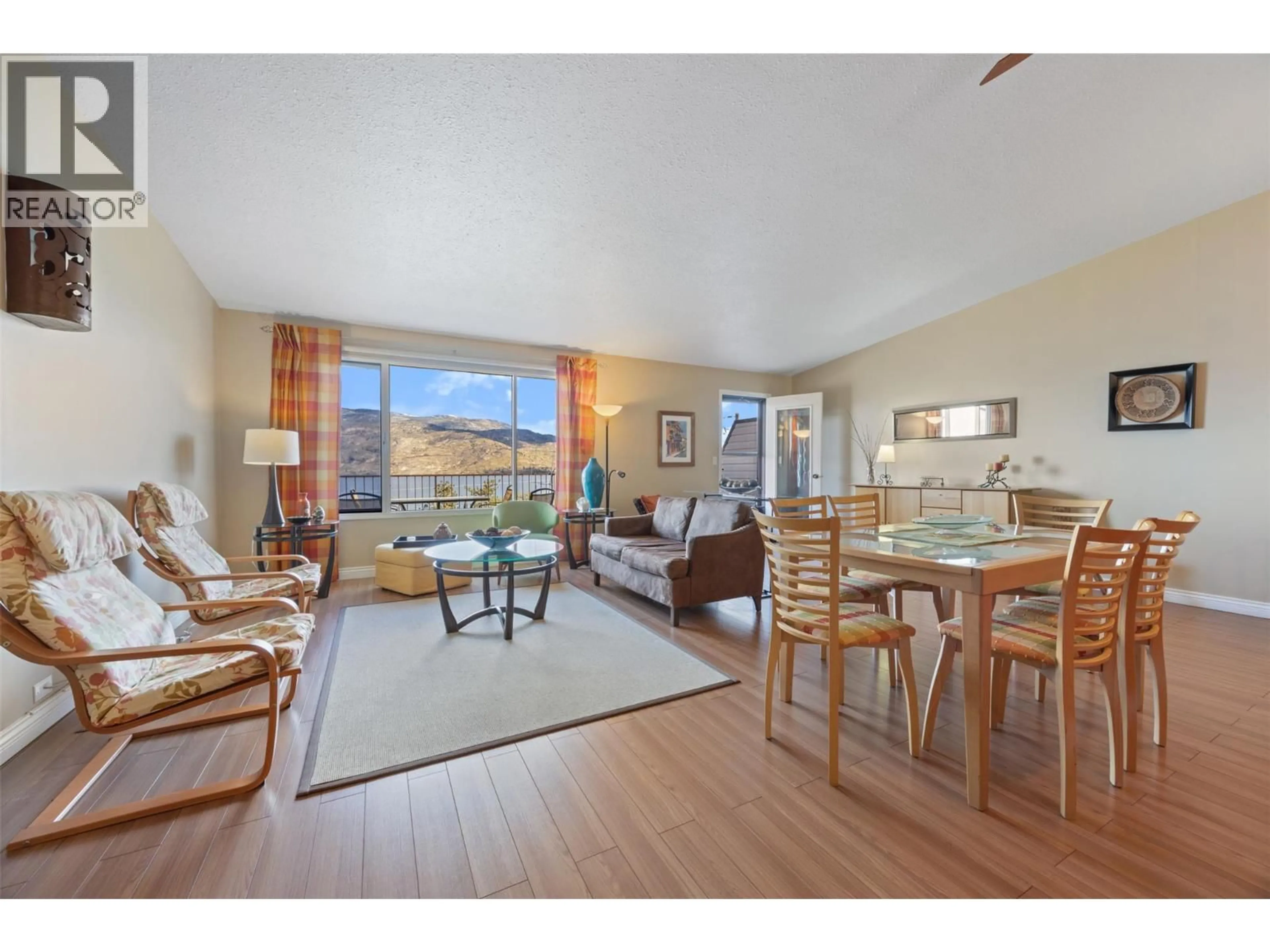 Living room with furniture, wood/laminate floor for 101 - 5970 PRINCESS STREET, Peachland British Columbia V0H1X7