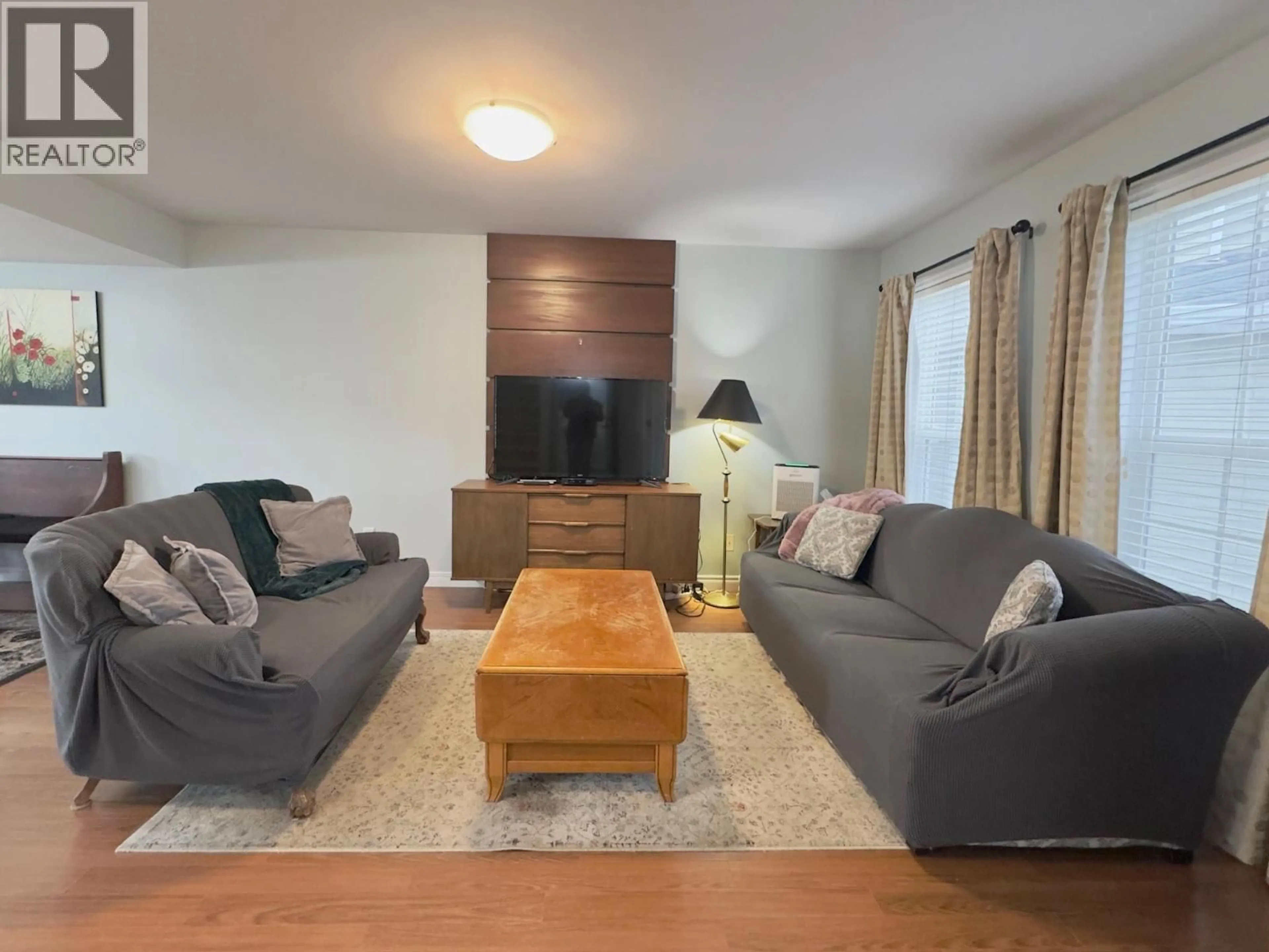 Living room with furniture, wood/laminate floor for 114 - 340 HASTINGS AVENUE, Penticton British Columbia V2A9B9