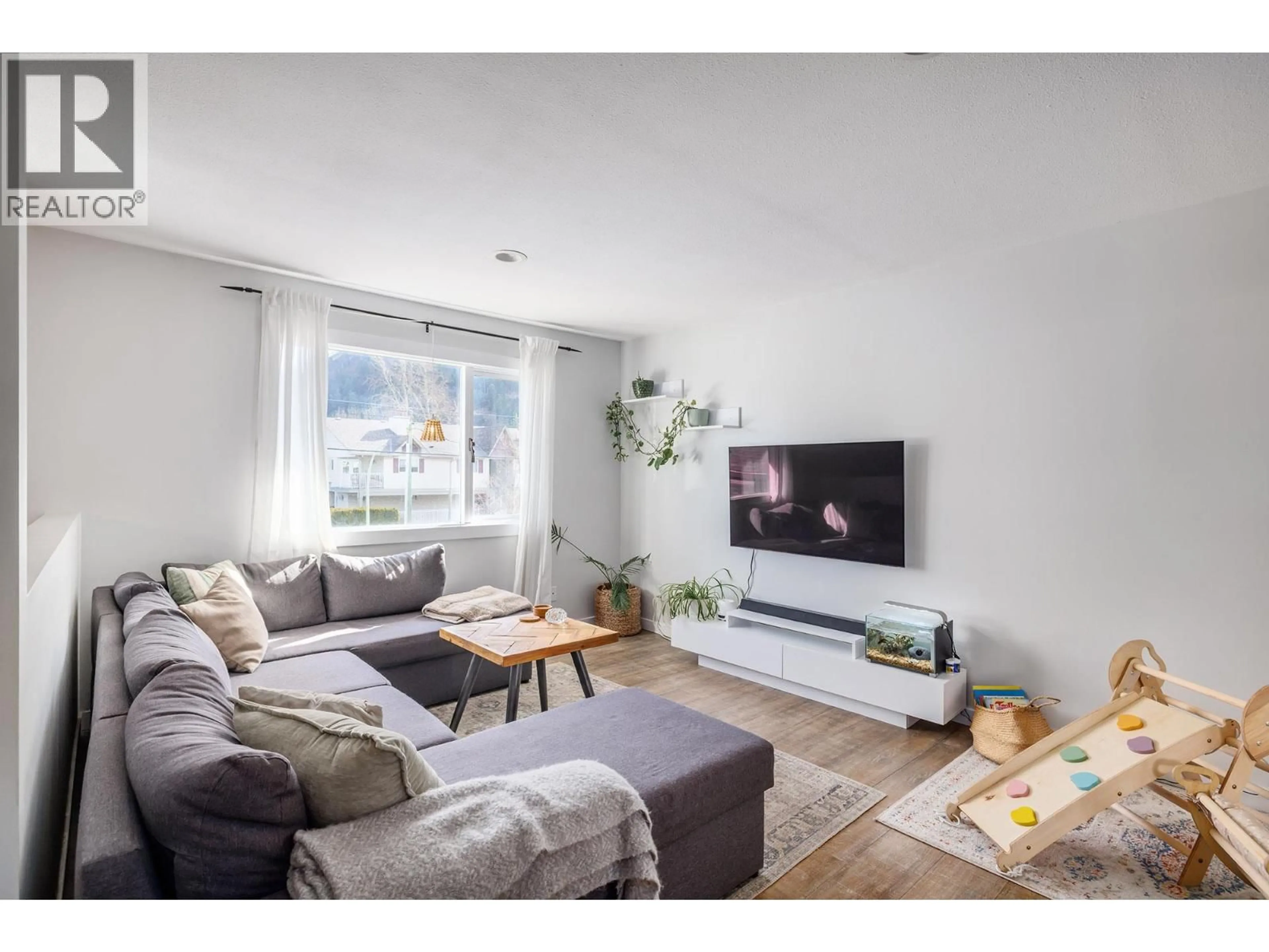 Living room with furniture, wood/laminate floor for 2728 RIFFINGTON PLACE, West Kelowna British Columbia V1Z3L1