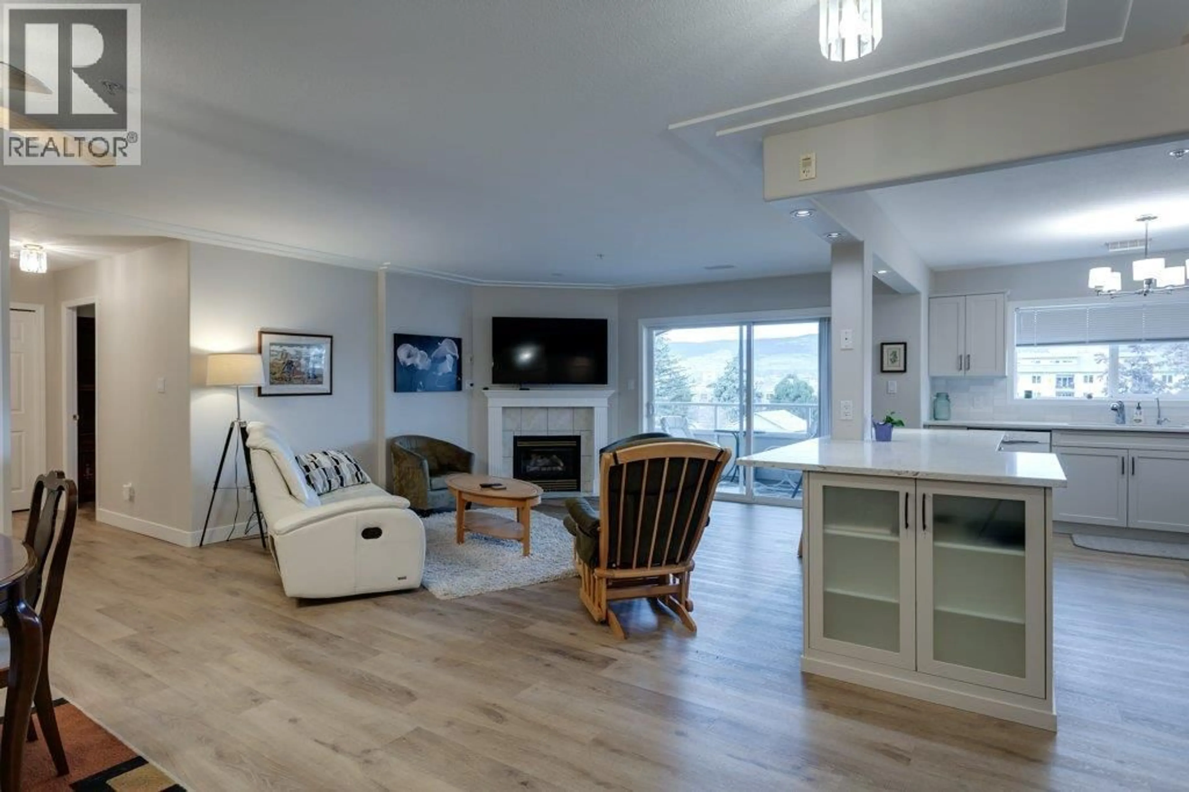 Living room with furniture, wood/laminate floor for 404 - 1895 AMBROSI ROAD, Kelowna British Columbia V1Y4R8