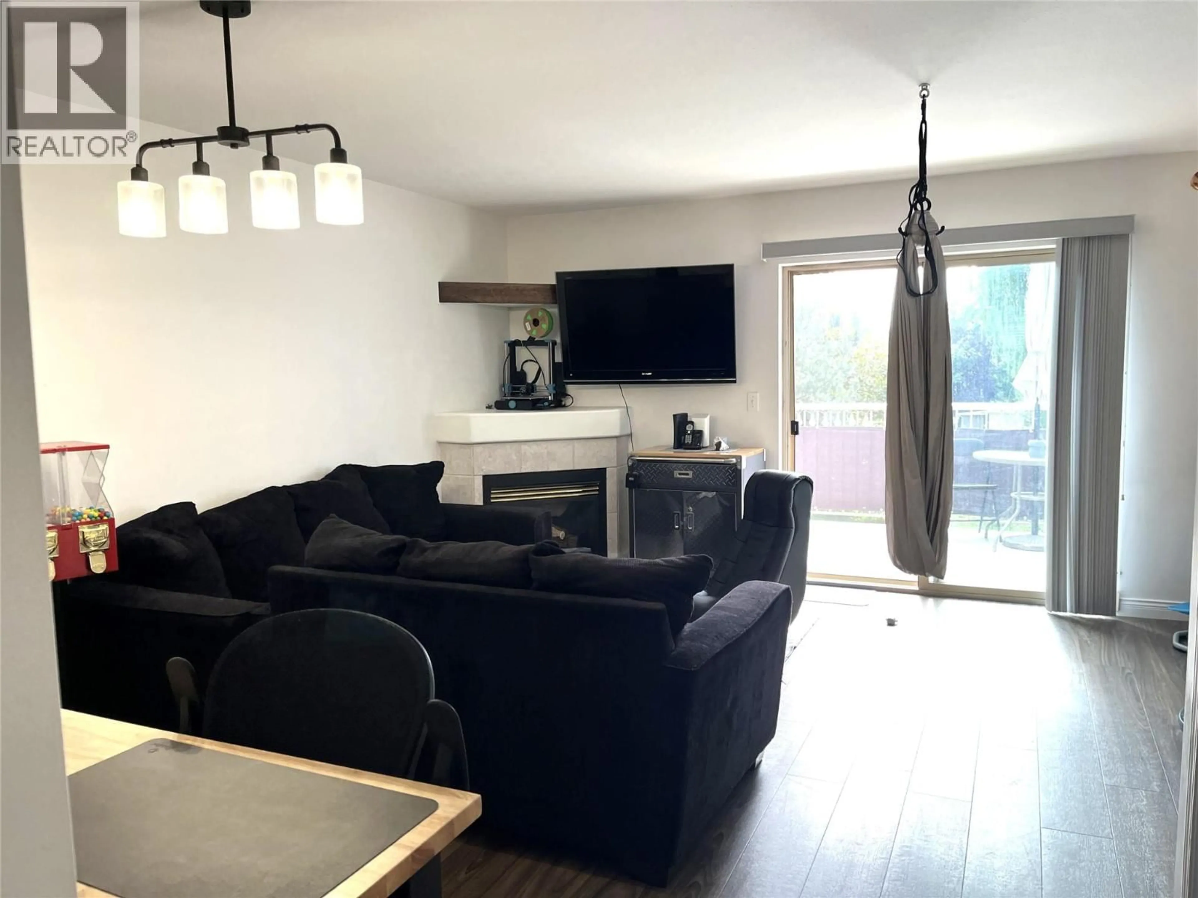 Living room with furniture, wood/laminate floor for 304 - 1607 43 AVENUE, Vernon British Columbia V1T9R9