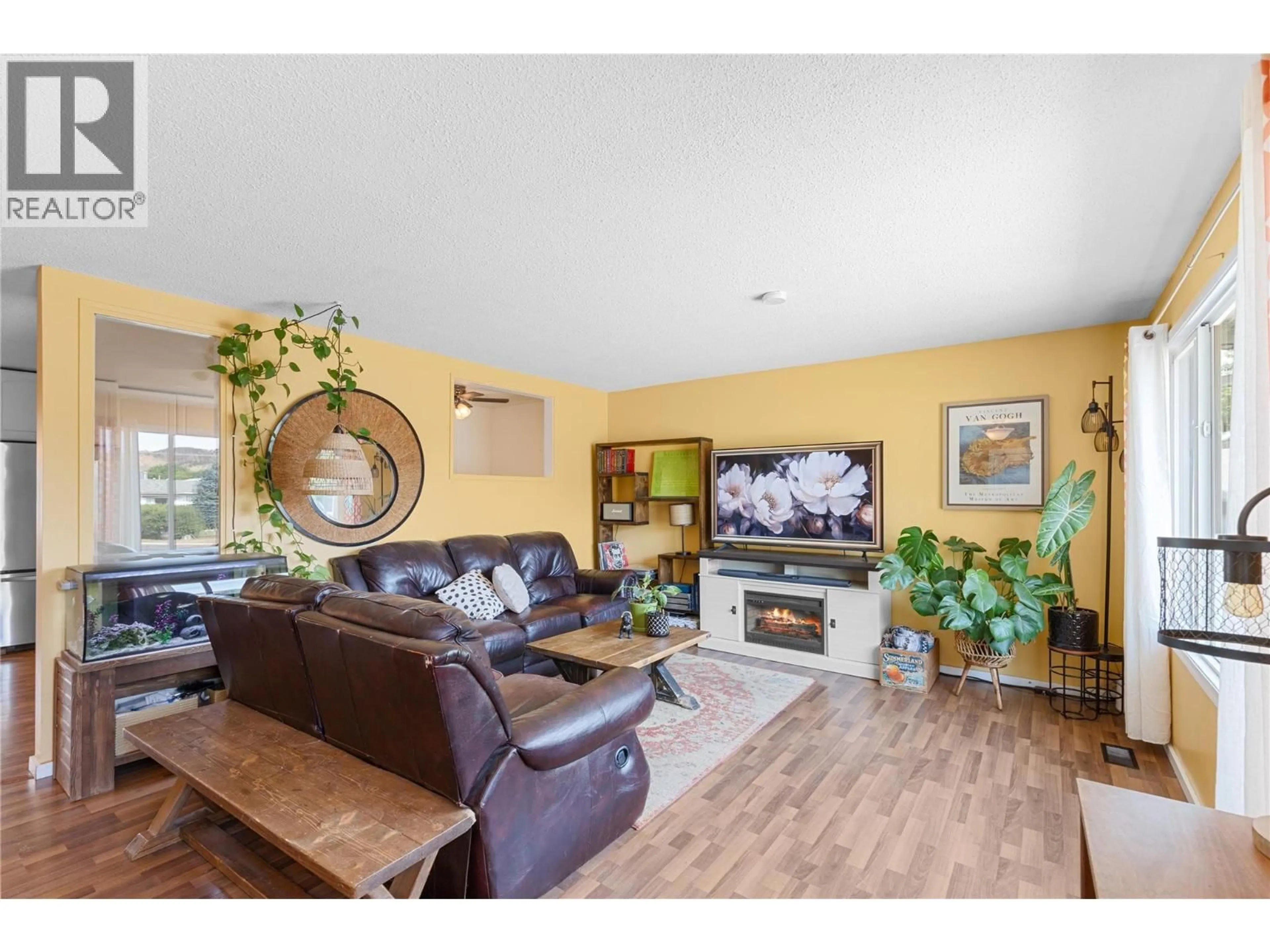Living room with furniture, wood/laminate floor for 1308 42A STREET, Vernon British Columbia V1T7T6