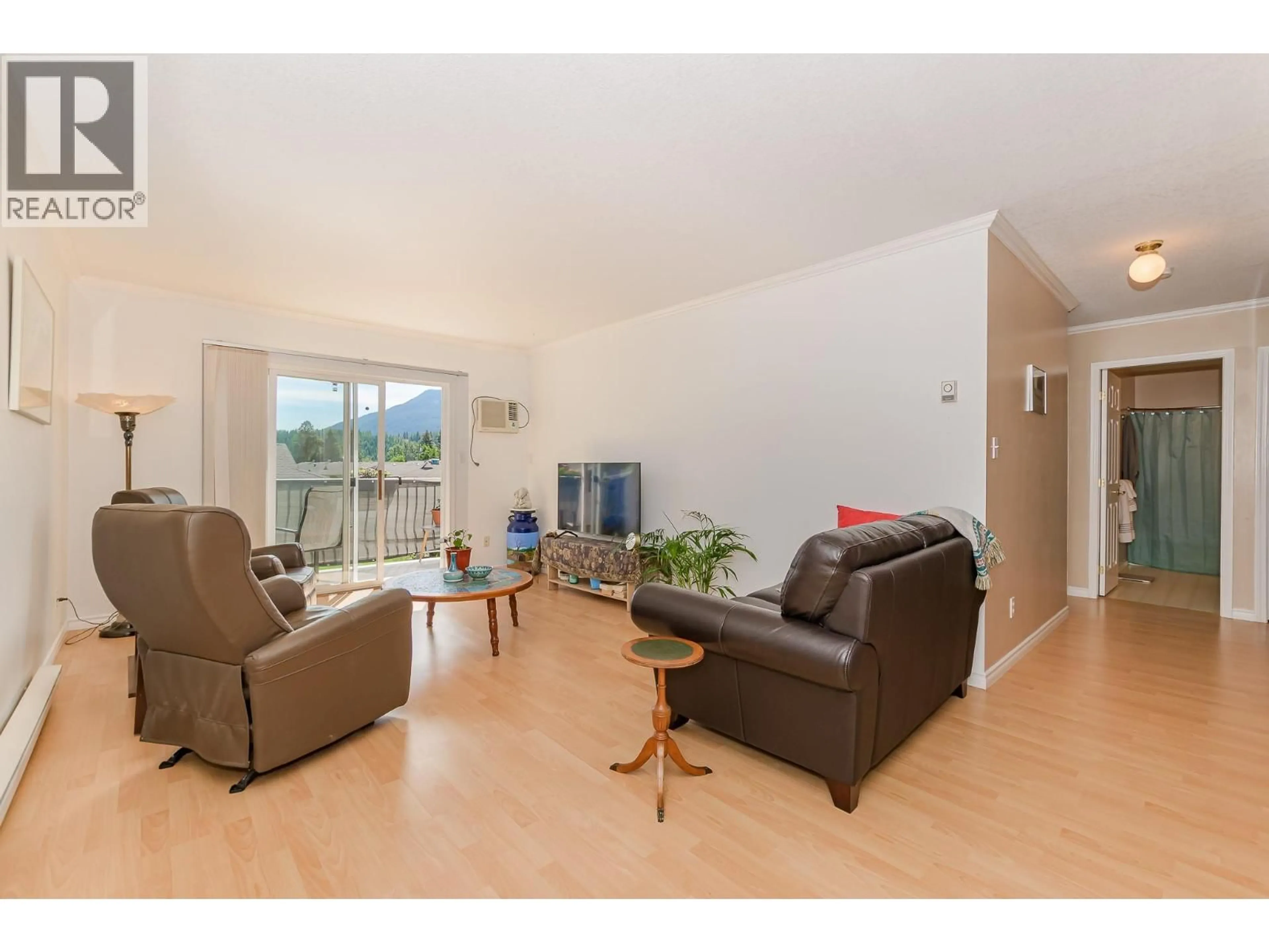 Living room with furniture, wood/laminate floor for 214 - 211 KILDONAN AVENUE, Enderby British Columbia V0E1V2