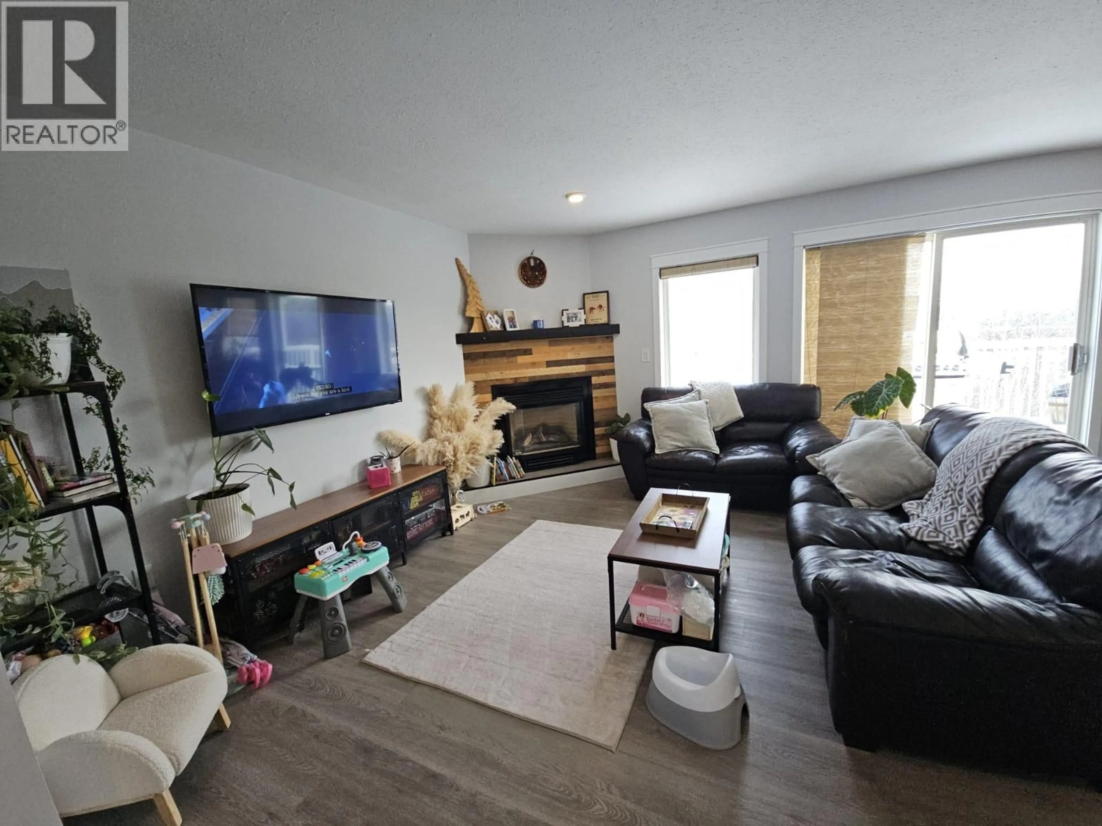 Living room with furniture, wood/laminate floor for 5153 45 AVENUE NORTHWEST, Chetwynd British Columbia V0C1J0