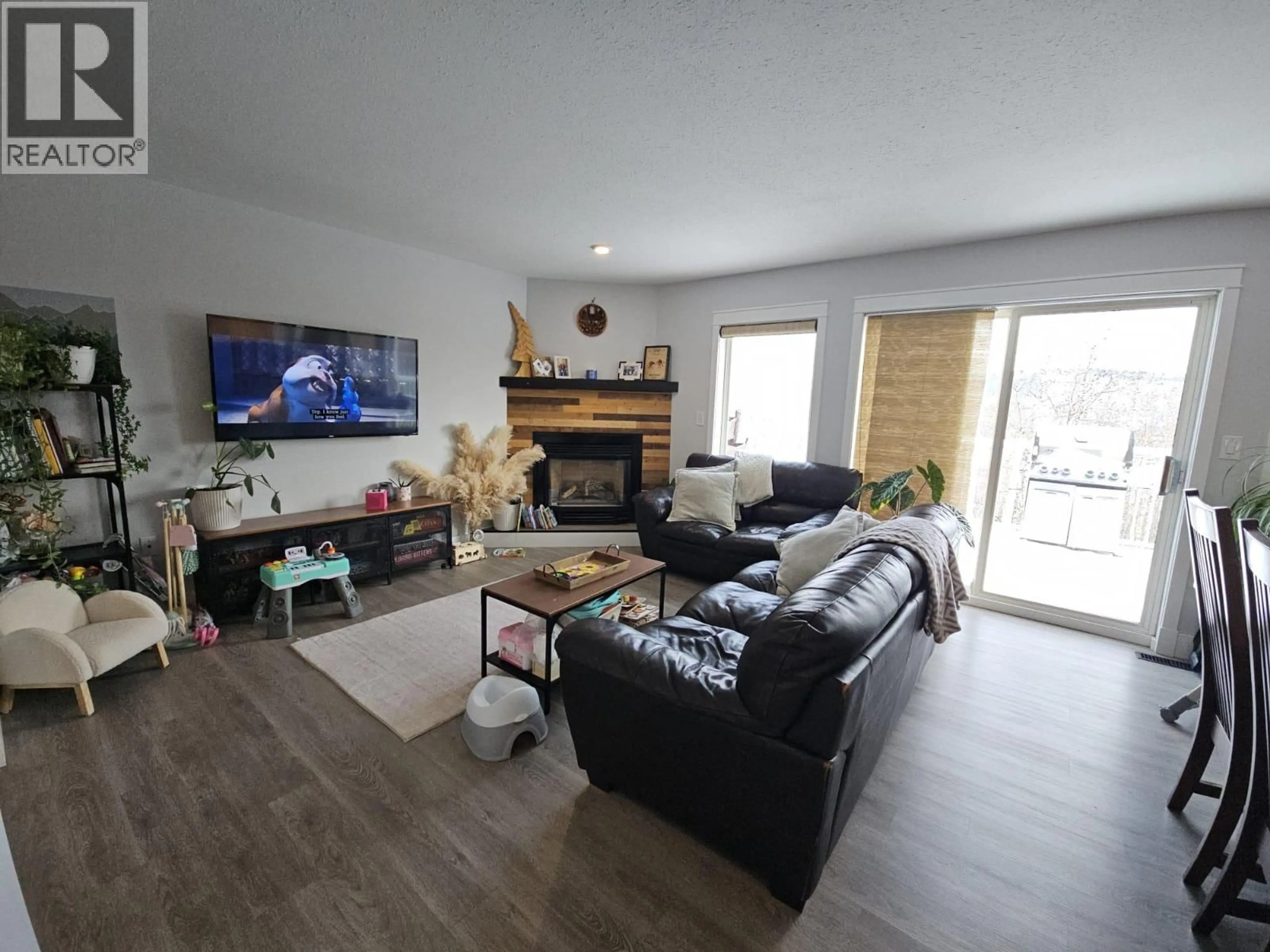 Living room with furniture, wood/laminate floor for 5153 45 AVENUE NORTHWEST, Chetwynd British Columbia V0C1J0
