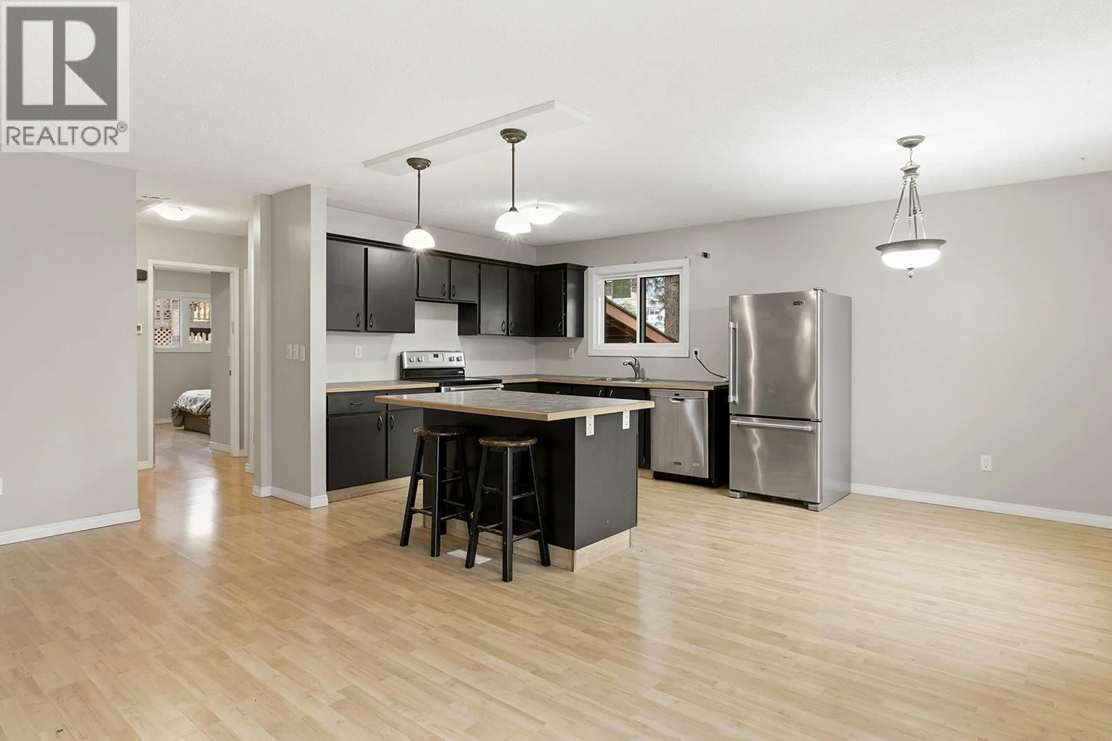 Open concept kitchen, wood/laminate floor for 5187 CHUTE LAKE CRESCENT, Kelowna British Columbia V1W4L7