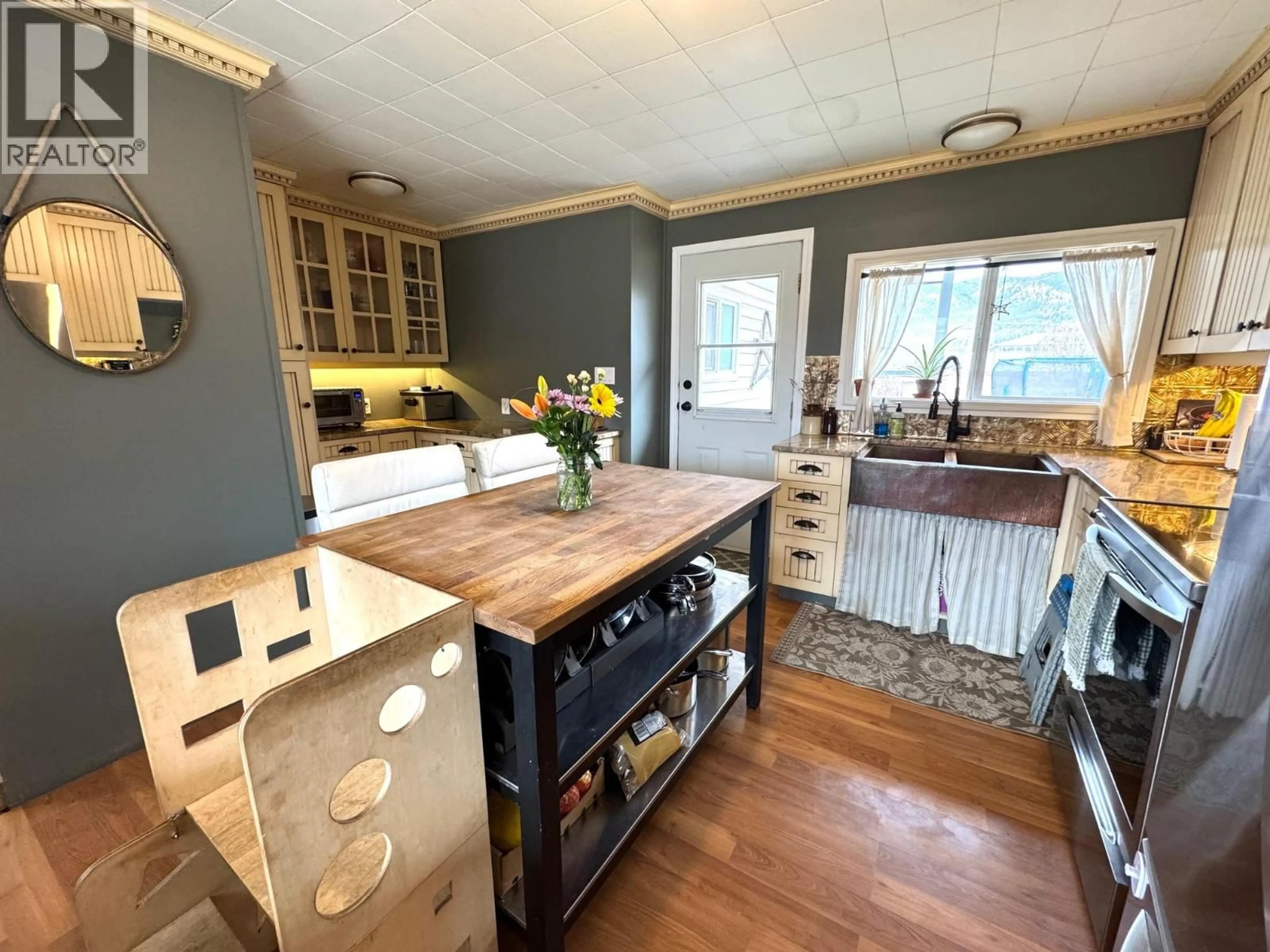 Open concept kitchen, wood/laminate floor for 1963 GRANITE AVENUE, Merritt British Columbia V1K1B8