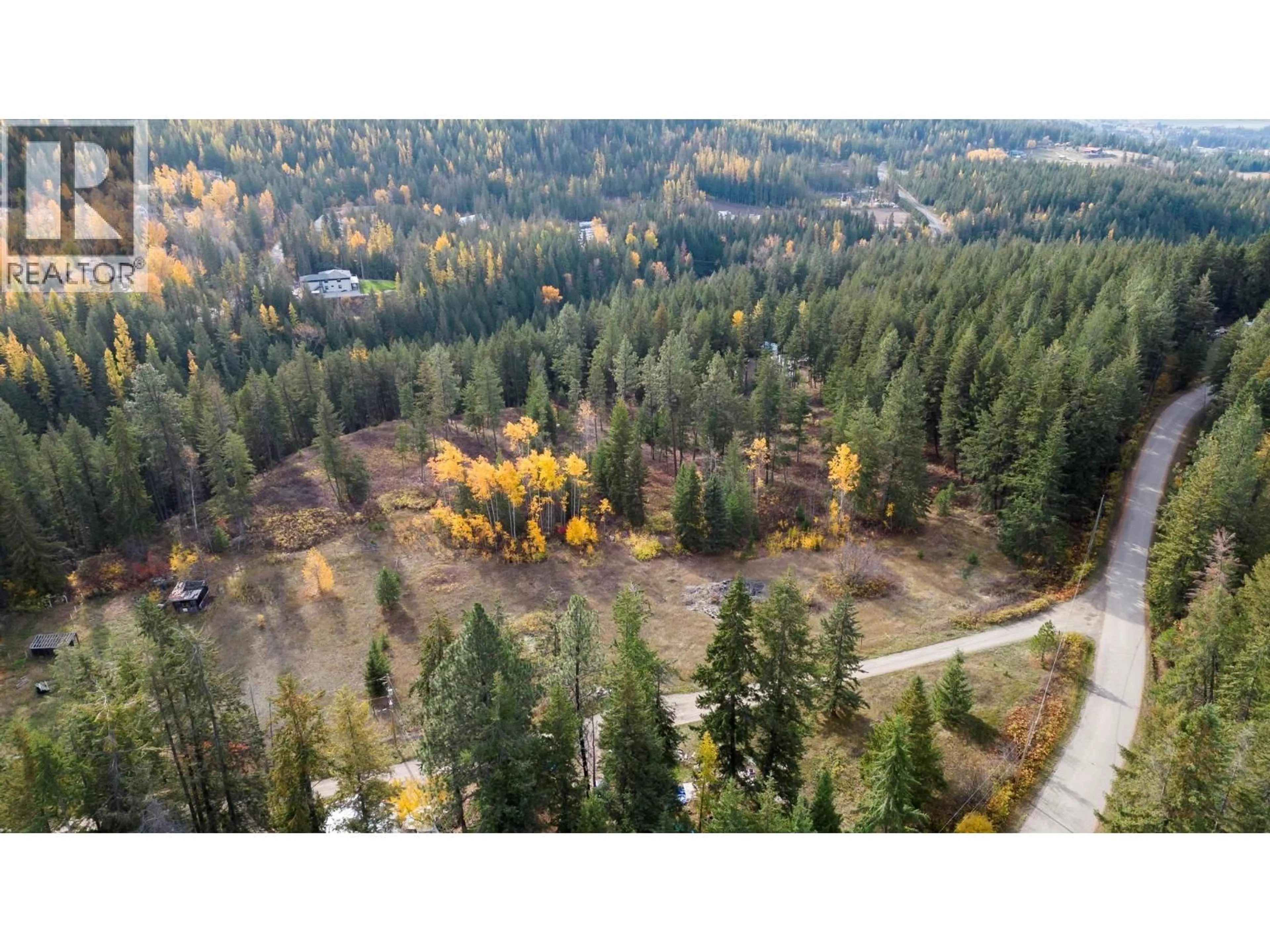A pic from outside/outdoor area/front of a property/back of a property/a pic from drone, forest/trees view for 7948 WALLACE ROAD, Vernon British Columbia V1B3N2