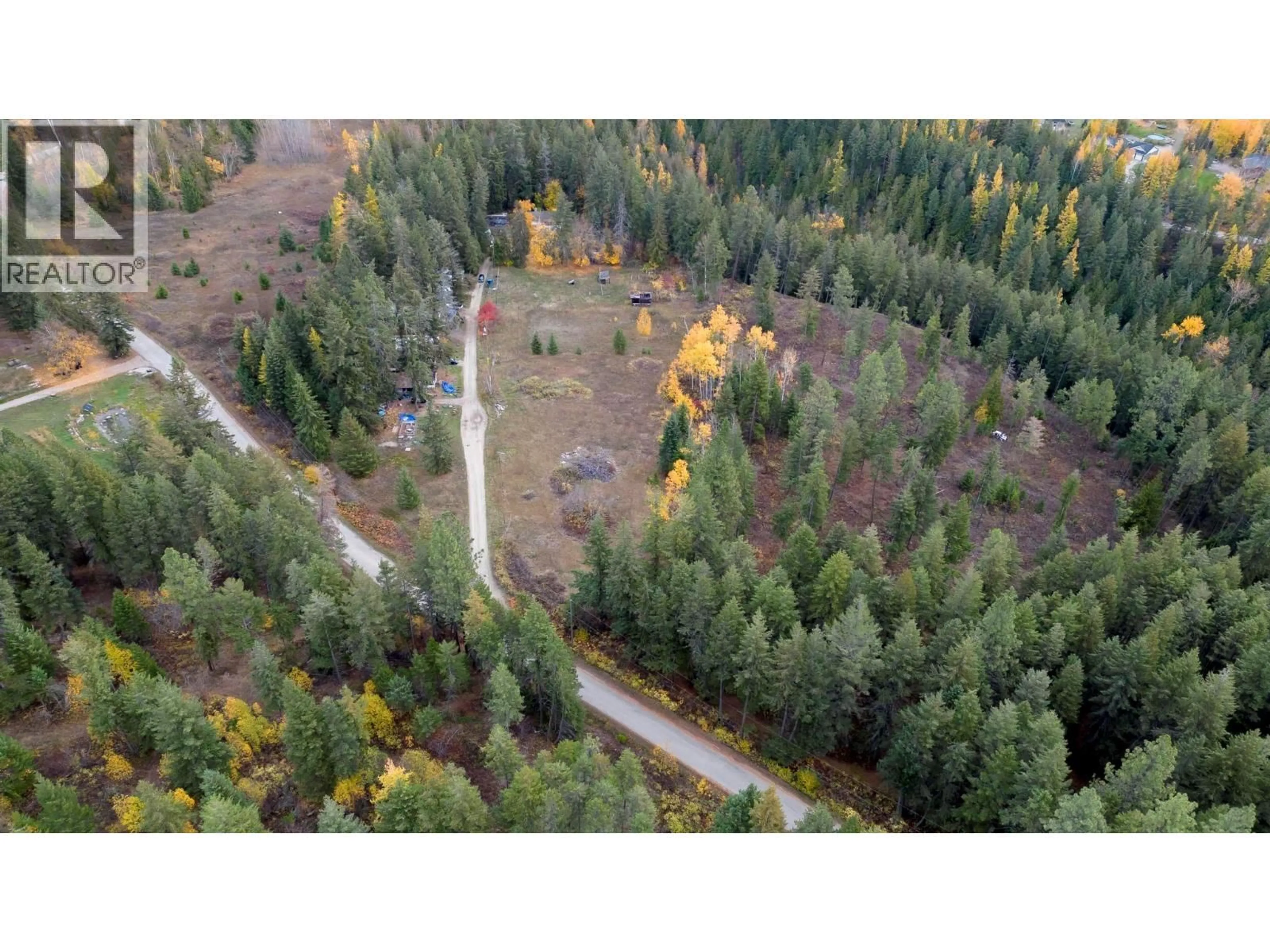 A pic from outside/outdoor area/front of a property/back of a property/a pic from drone, forest/trees view for 7948 WALLACE ROAD, Vernon British Columbia V1B3N2