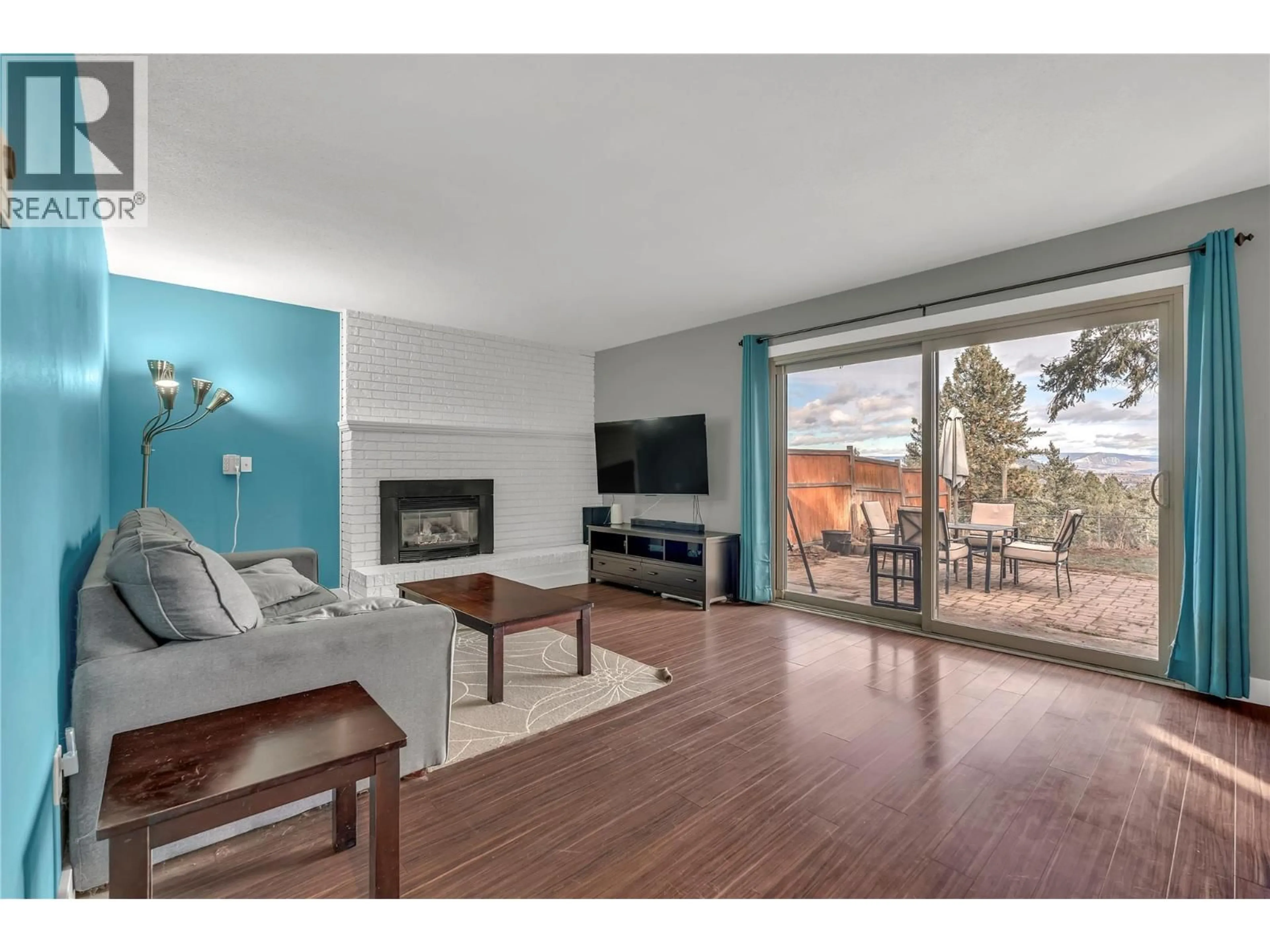 Living room with furniture, wood/laminate floor for 3472 MCIVER ROAD, West Kelowna British Columbia V4T1H8