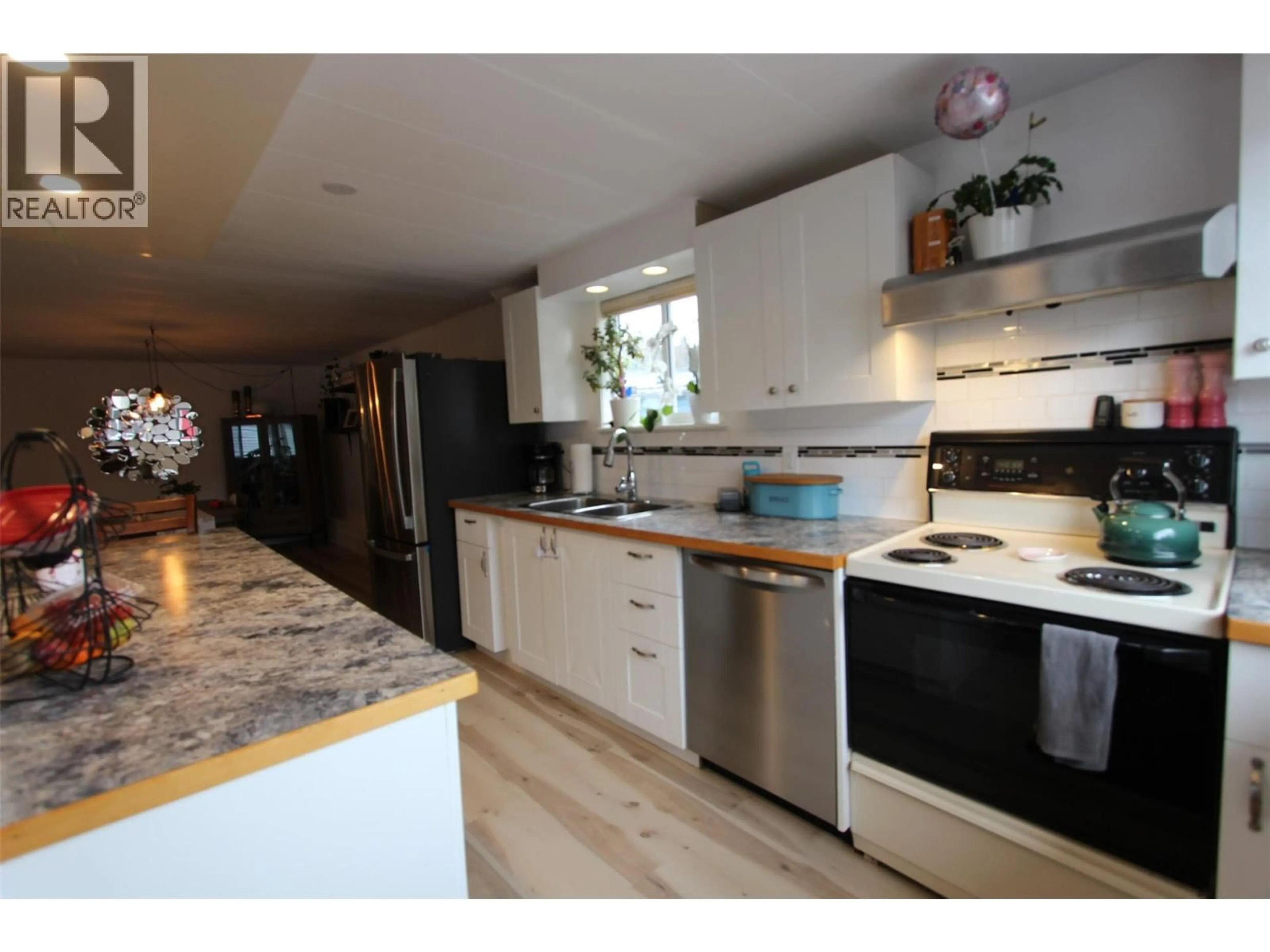 Open concept kitchen, wood/laminate floor for E15 60 COKATO ROAD, Fernie British Columbia V0B1M4