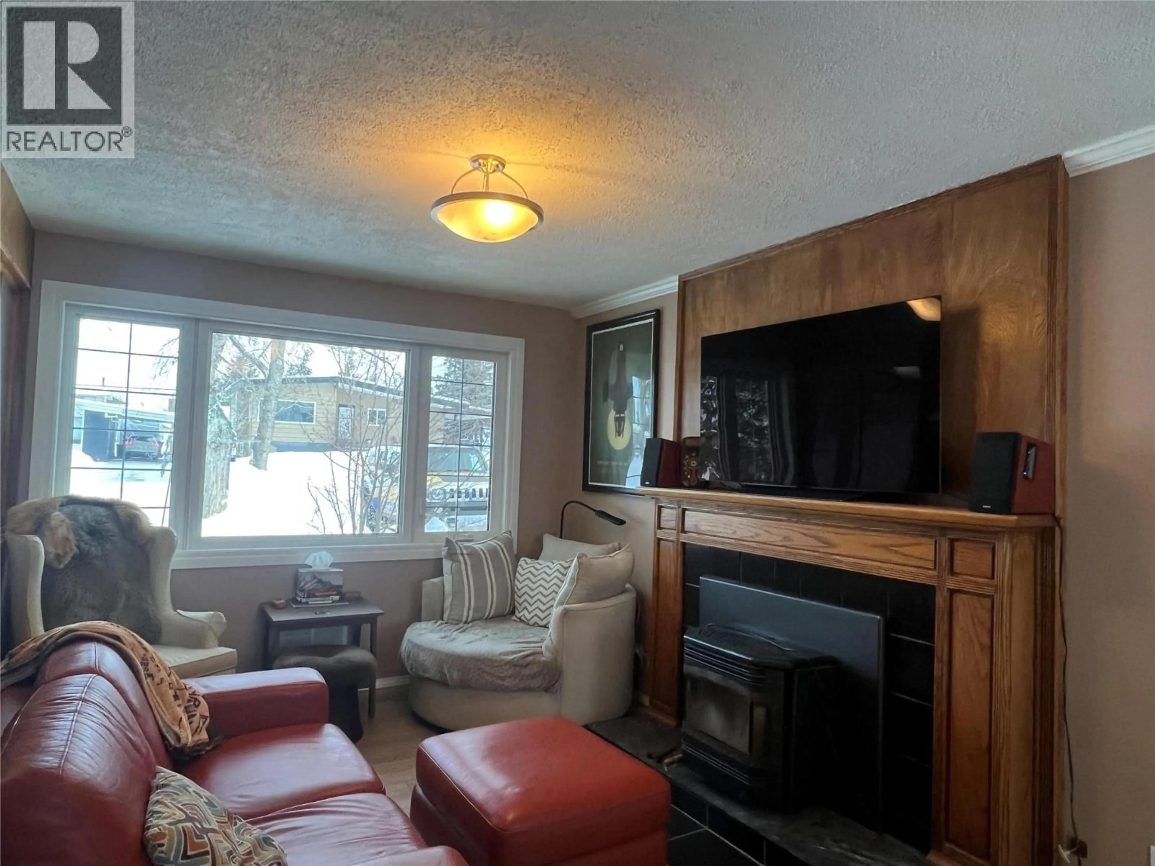 Living room with furniture, wood/laminate floor for 1713 90 AVENUE, Dawson Creek British Columbia V1G1A5