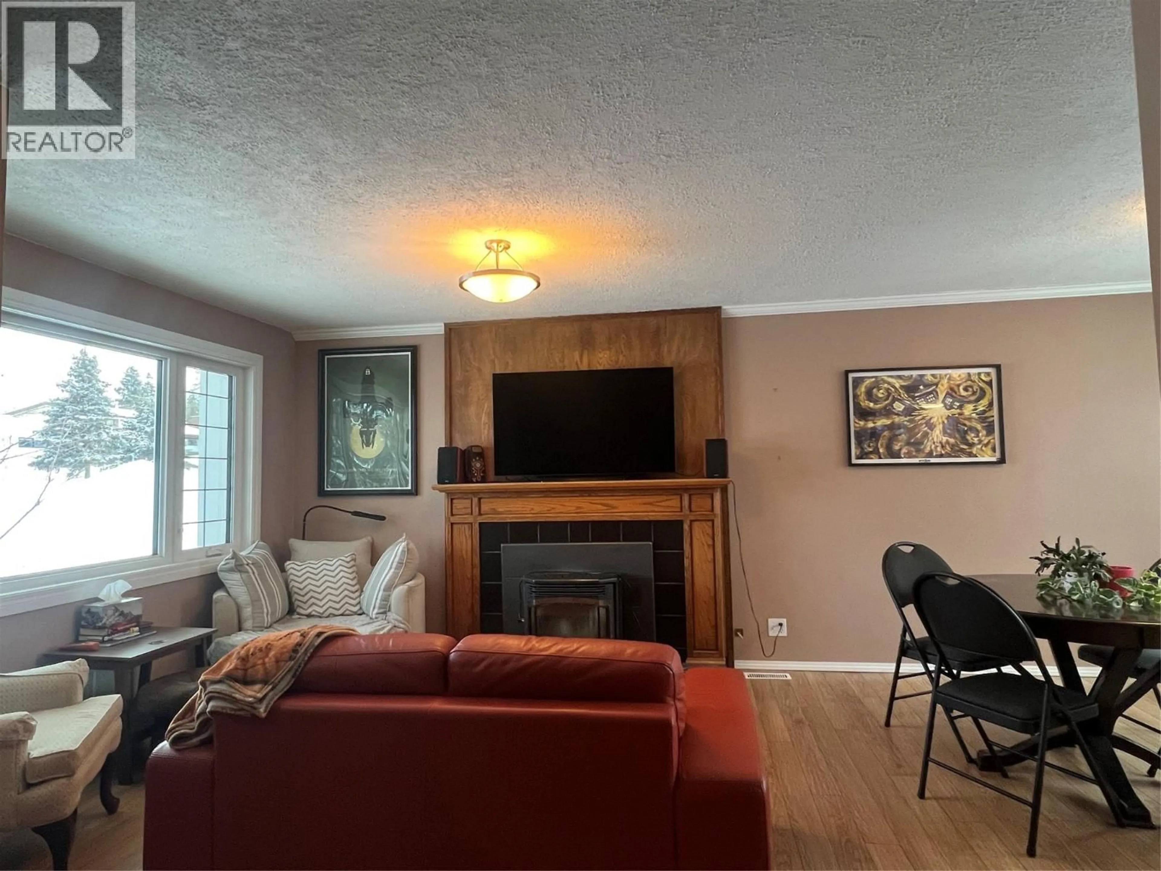 Living room with furniture, wood/laminate floor for 1713 90 AVENUE, Dawson Creek British Columbia V1G1A5