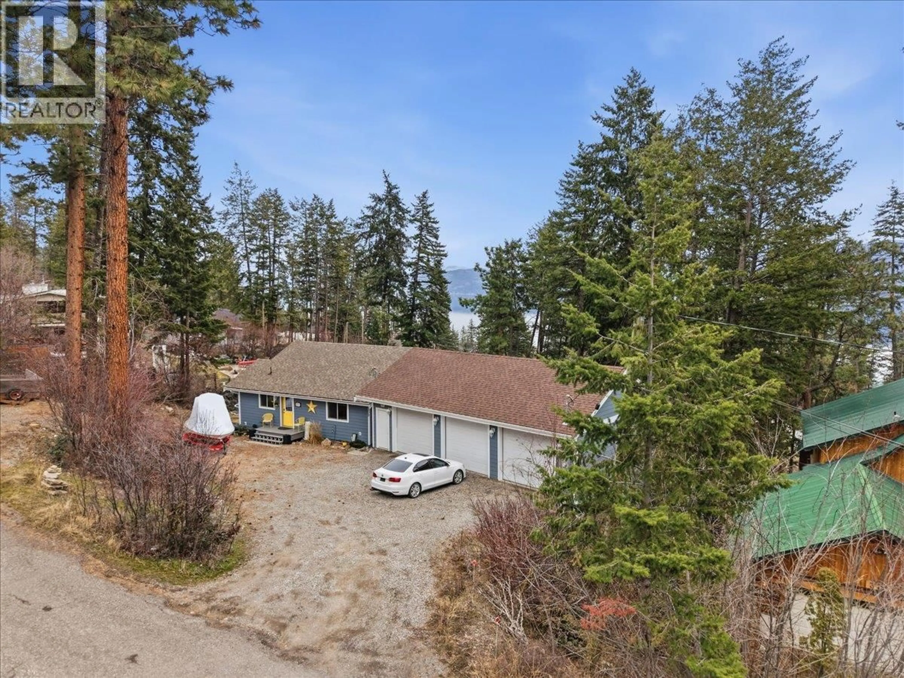 A pic from outside/outdoor area/front of a property/back of a property/a pic from drone, forest/trees view for 309 KILLARNEY WAY, Vernon British Columbia V1H2C5