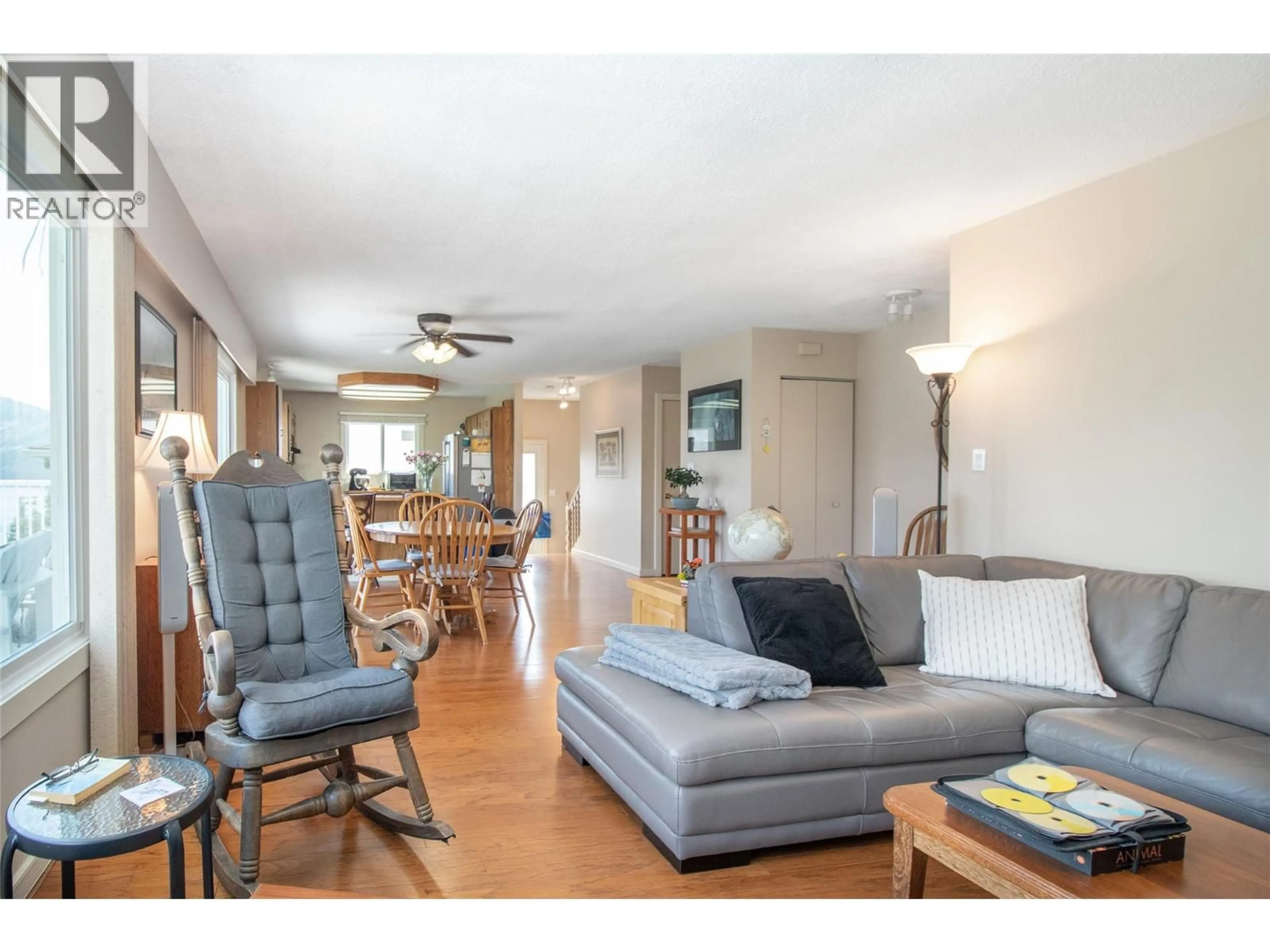 Living room with furniture, wood/laminate floor for 6335 TOPHAM PLACE, Peachland British Columbia V0H1X0