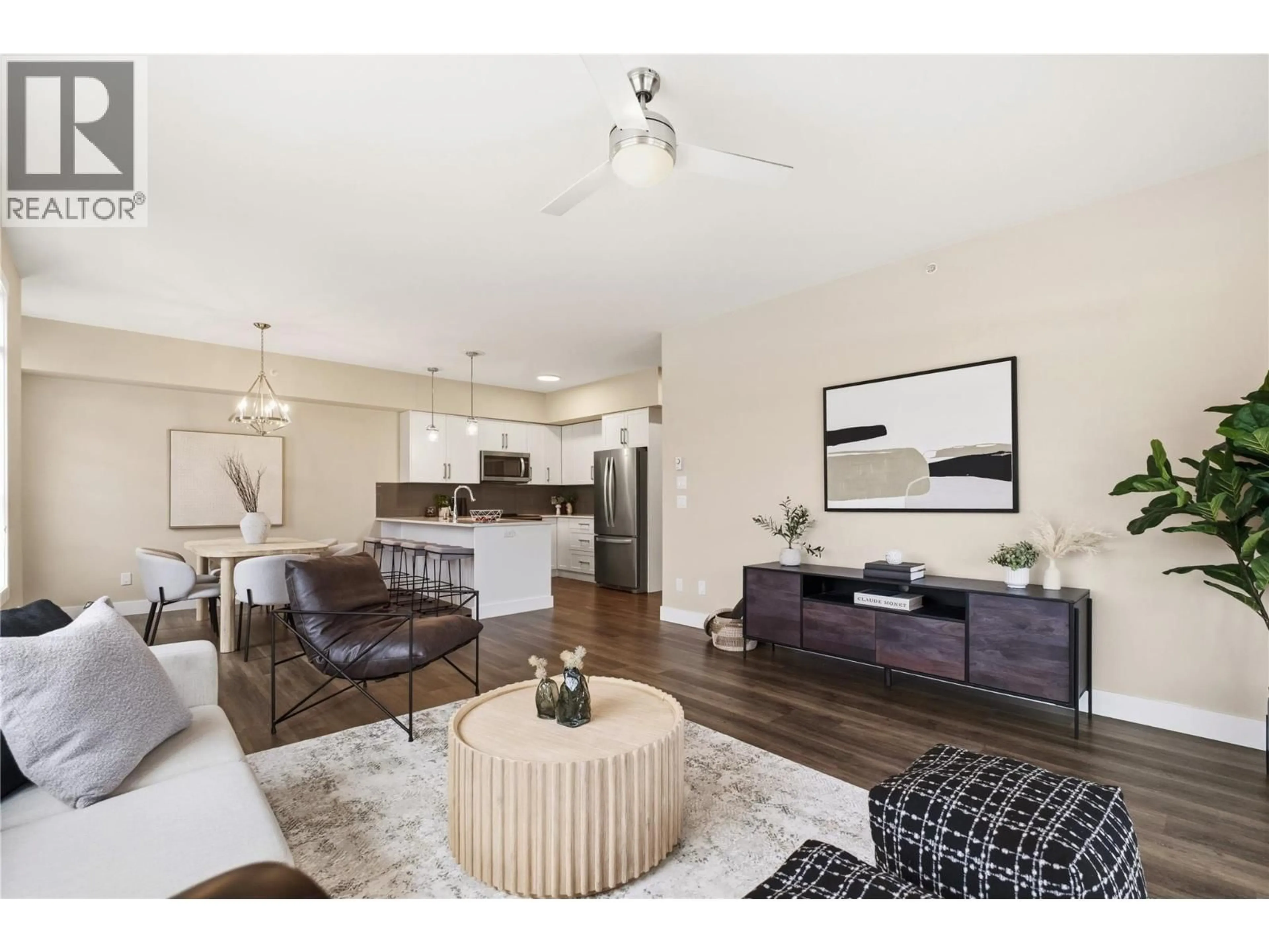 Living room with furniture, wood/laminate floor for 313 - 3090 BURTCH ROAD, Kelowna British Columbia V1W5G9