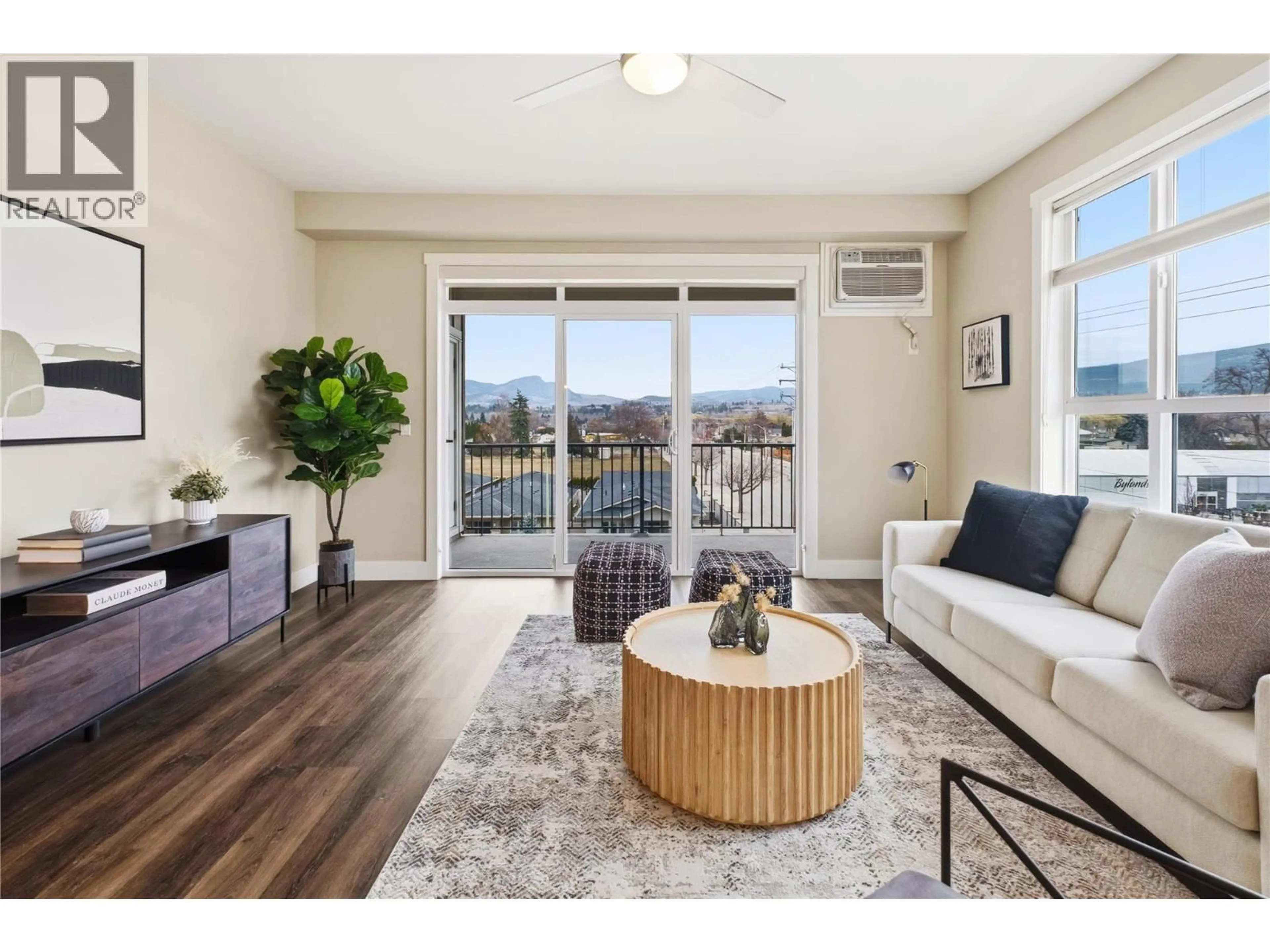 Living room with furniture, wood/laminate floor for 313 - 3090 BURTCH ROAD, Kelowna British Columbia V1W5G9