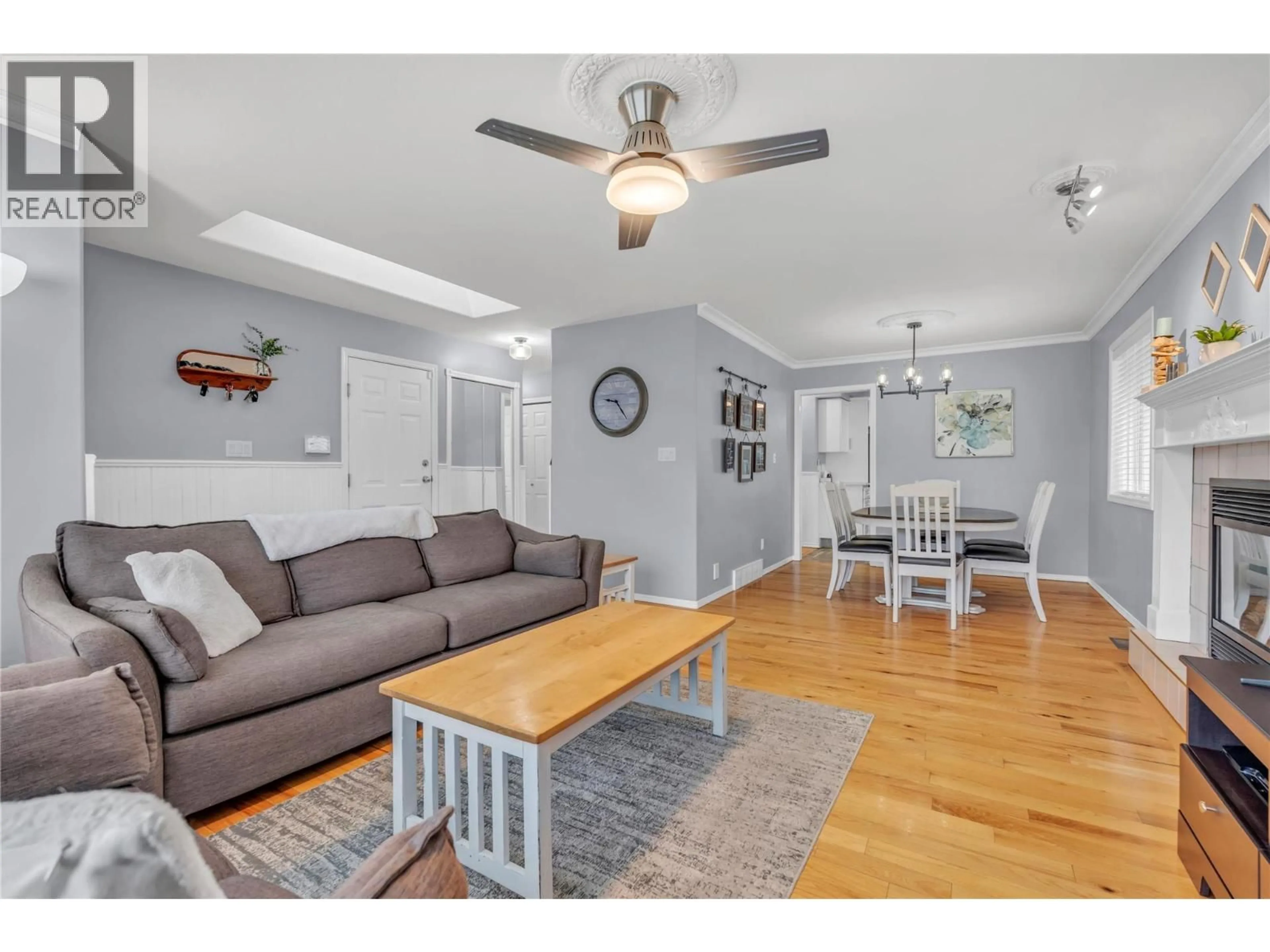 Living room with furniture, wood/laminate floor for 119 HUTH AVENUE, Penticton British Columbia V2A2Z7