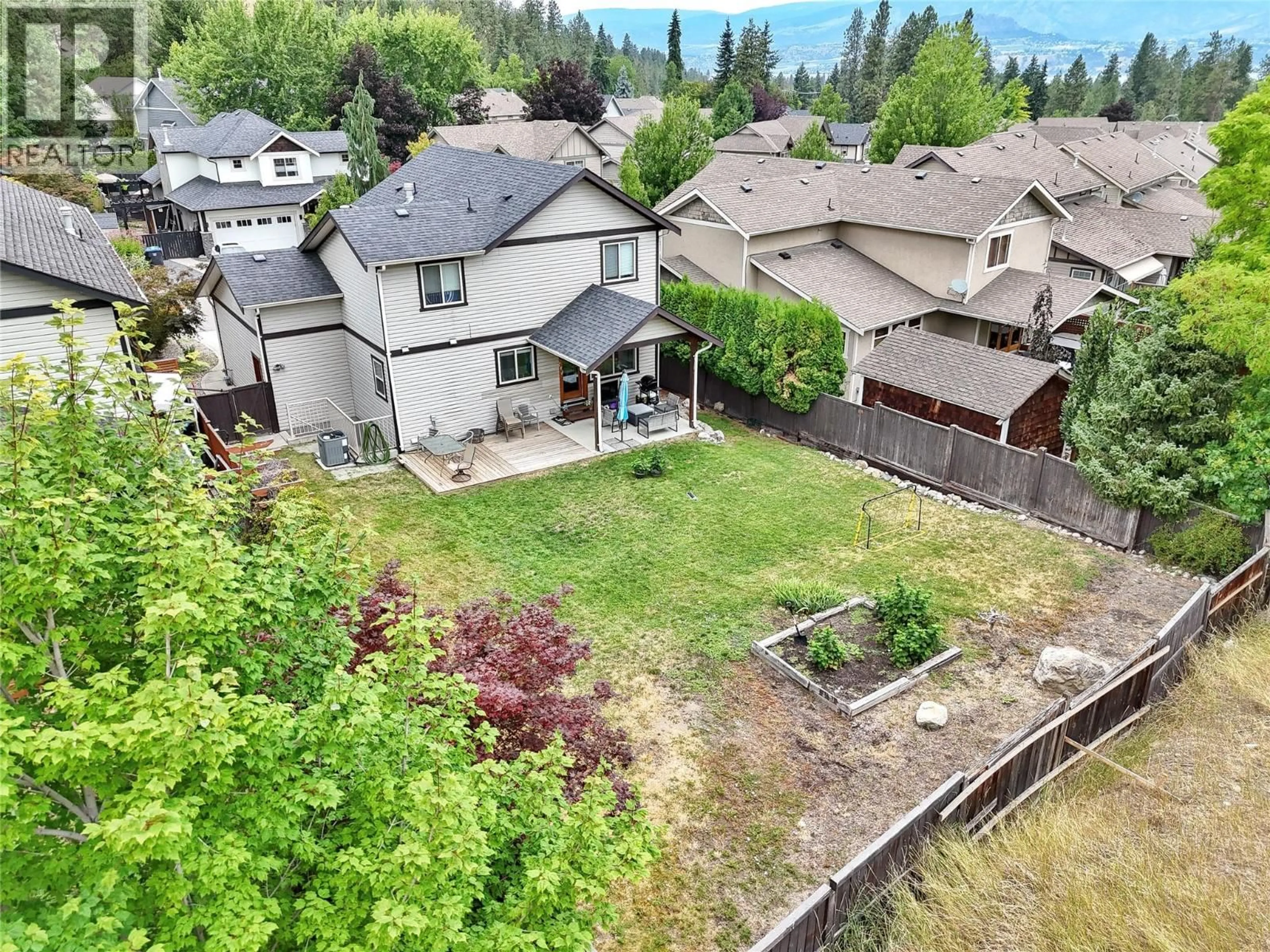A pic from outside/outdoor area/front of a property/back of a property/a pic from drone, mountain view for 982 PARET CRESCENT, Kelowna British Columbia V1W4X9