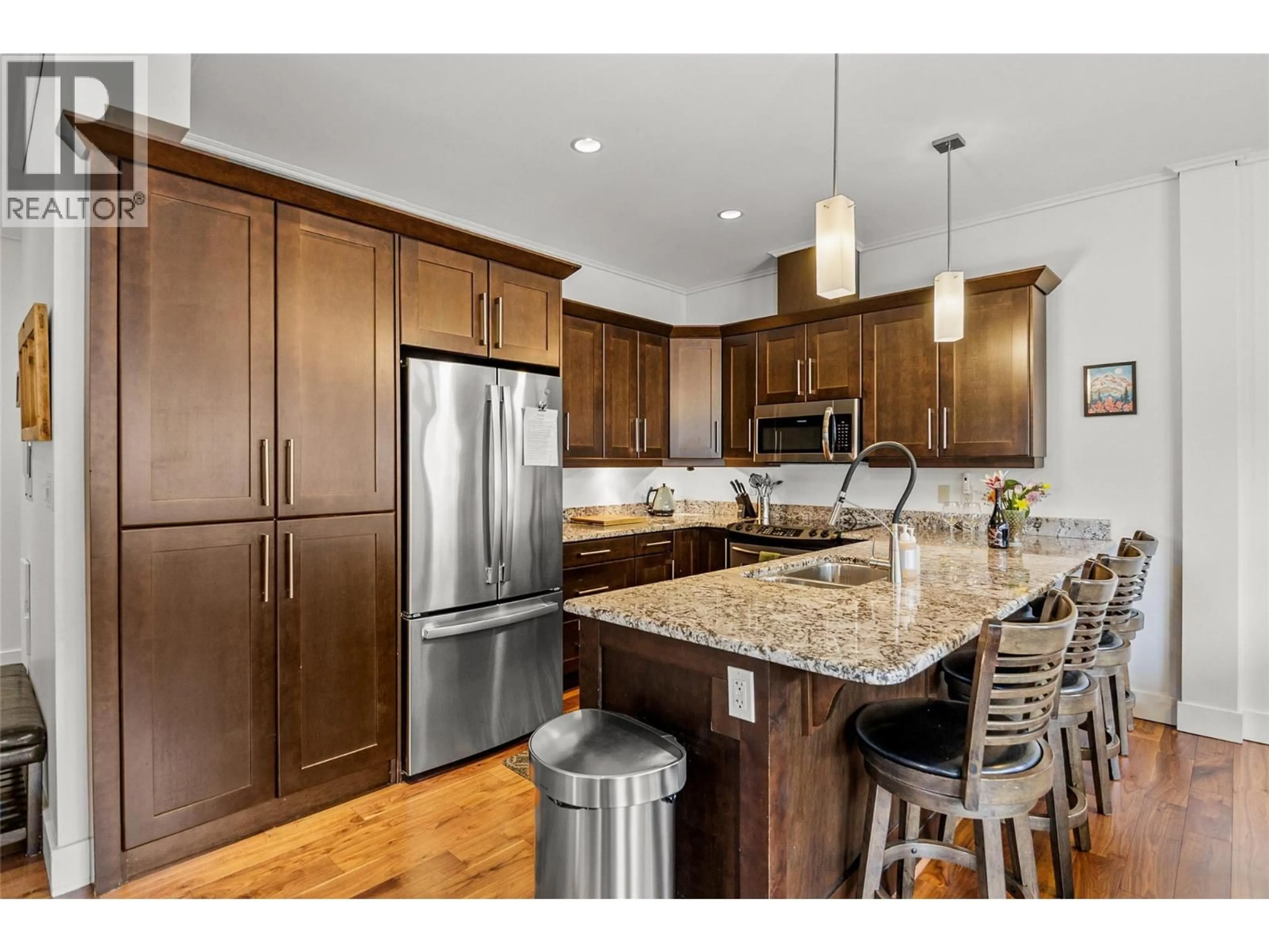Open concept kitchen, wood/laminate floor for 301 - 309 1 STREET WEST, Revelstoke British Columbia V0E2S0