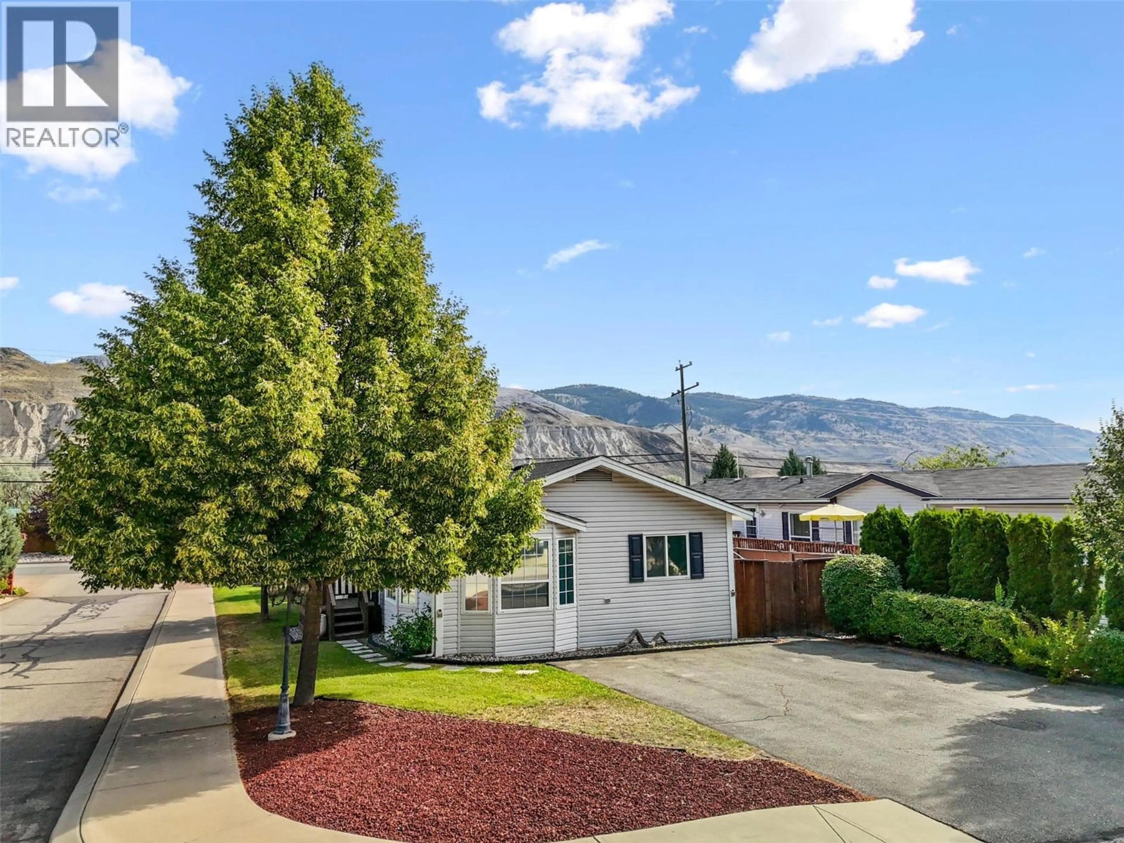 A pic from outside/outdoor area/front of a property/back of a property/a pic from drone, mountain view for 1 - 7545 DALLAS DRIVE, Kamloops British Columbia V2C6X5