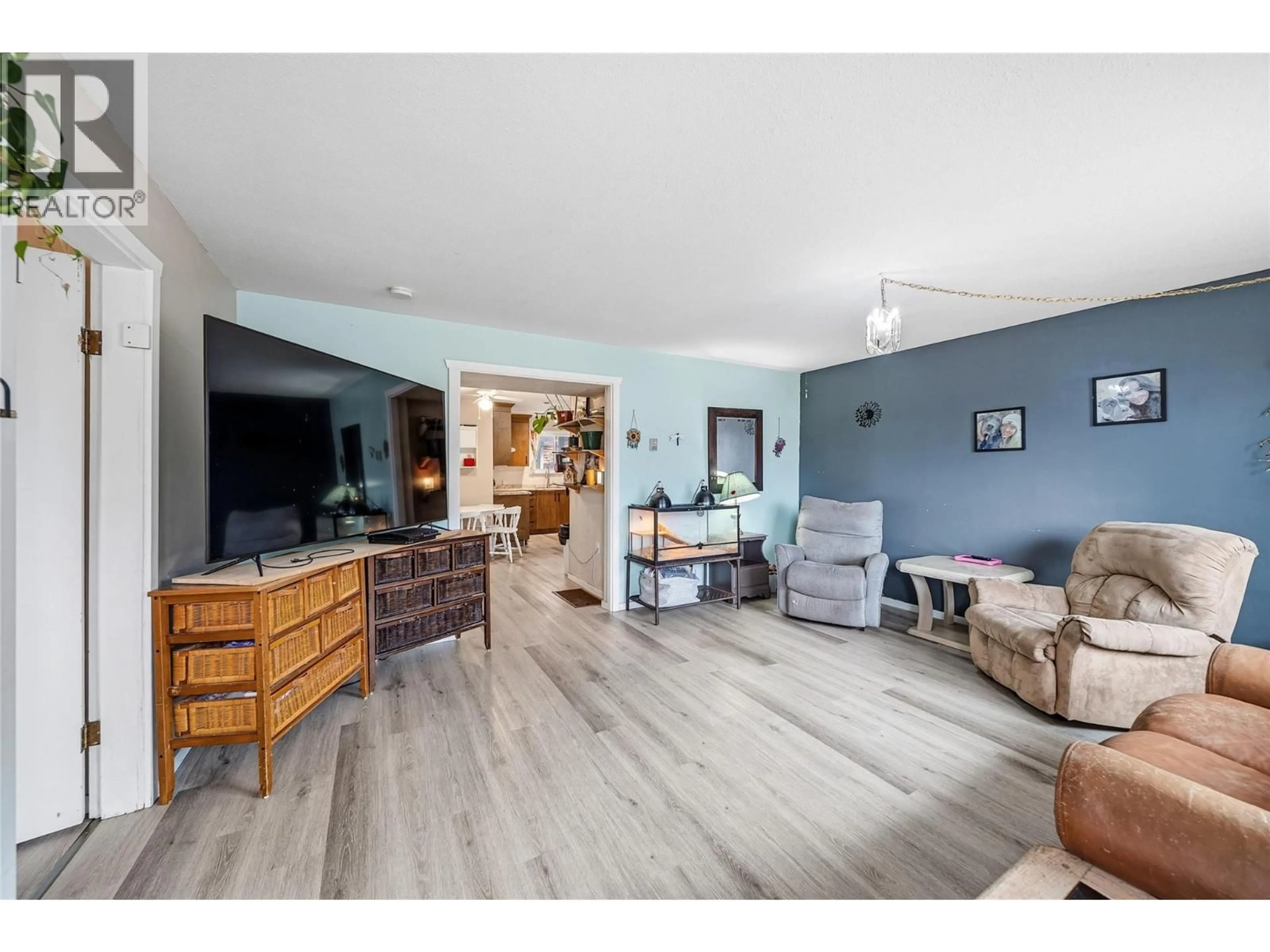 Living room with furniture, wood/laminate floor for 1950 HILL STREET, Merritt British Columbia V1K1L4