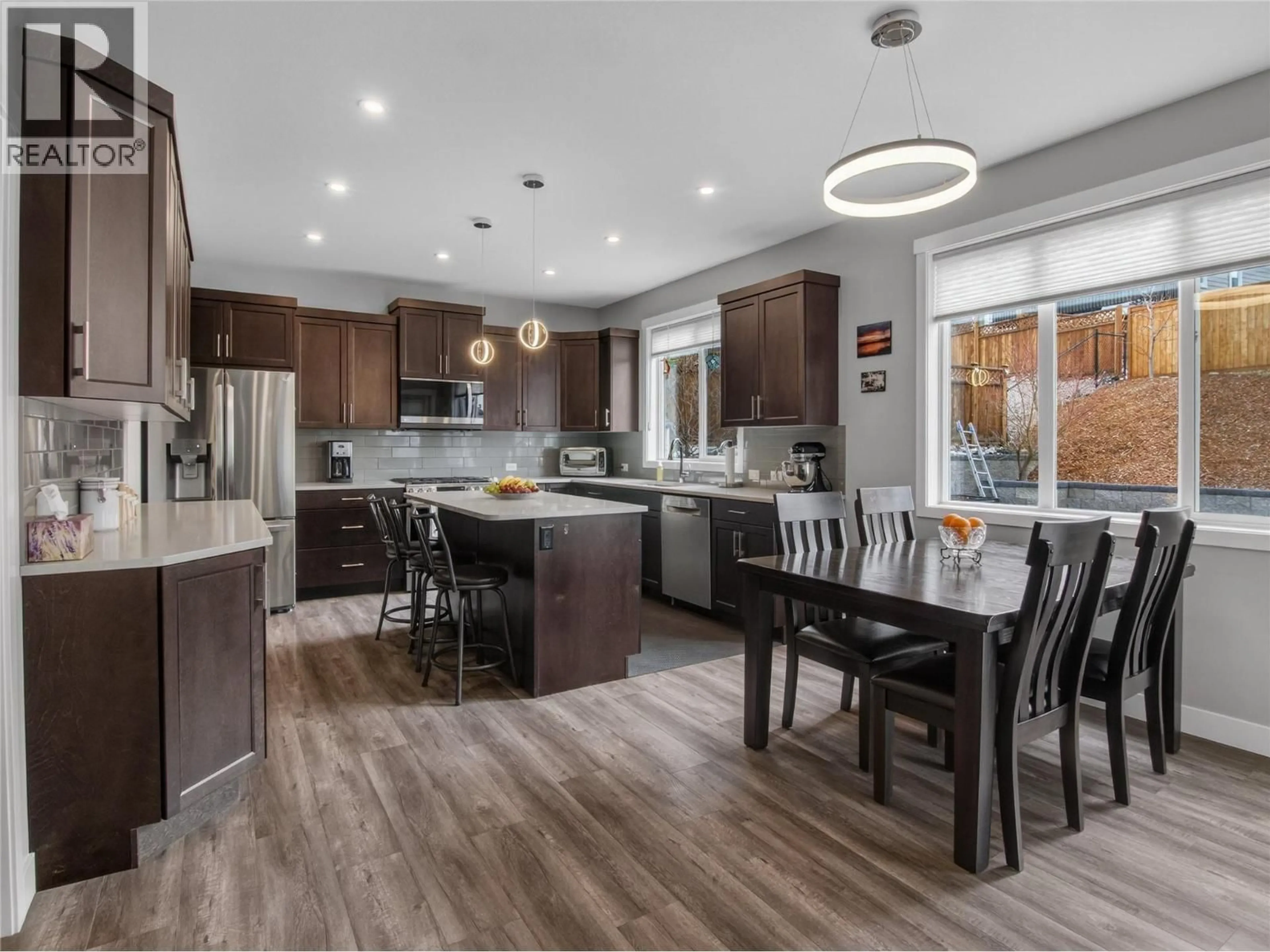 Open concept kitchen, wood/laminate floor for 2070 LAWRENCE AVENUE, Penticton British Columbia V2A9G6