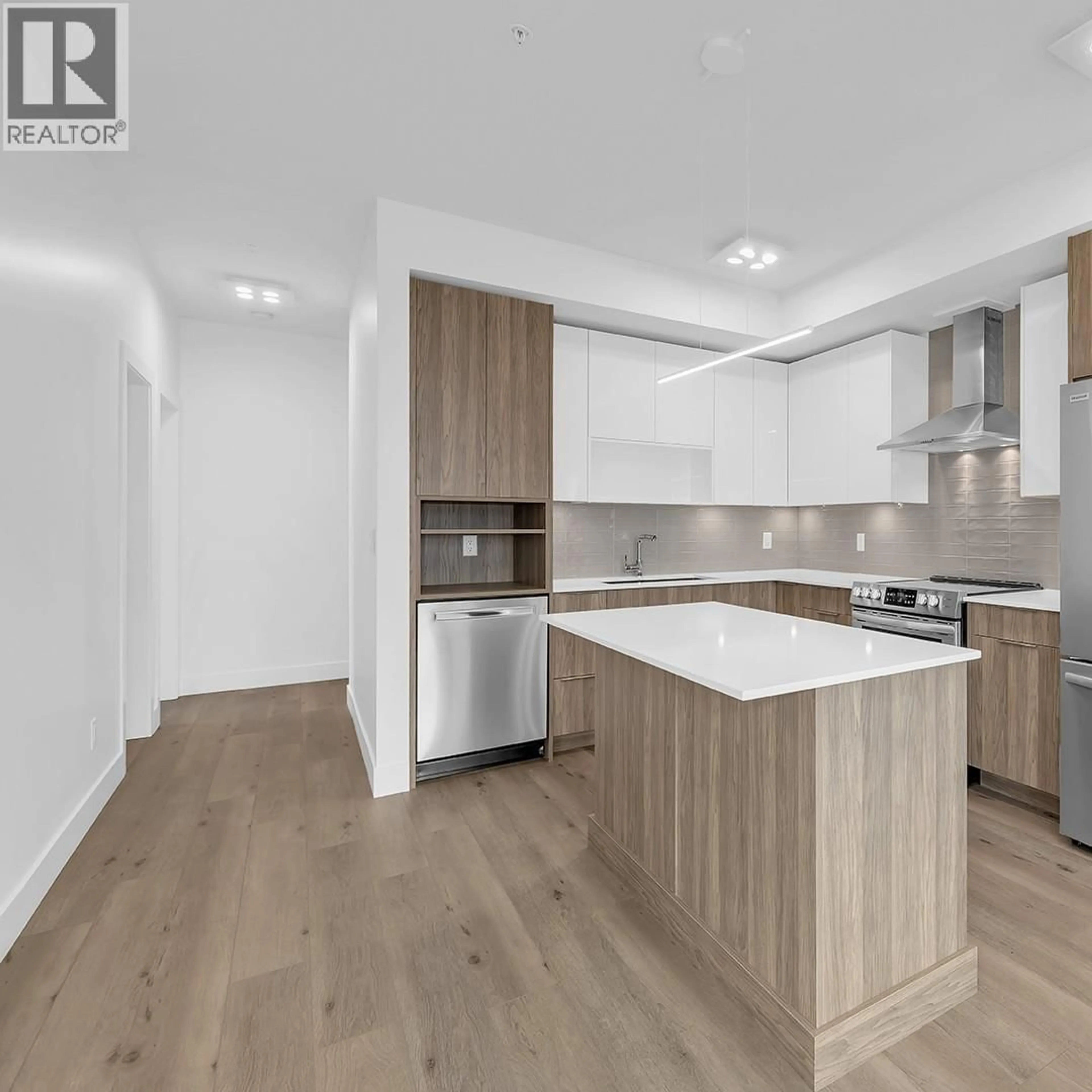 Open concept kitchen, wood/laminate floor for 502C - 3642 MISSION SPRINGS DRIVE, Kelowna British Columbia V1W0E1