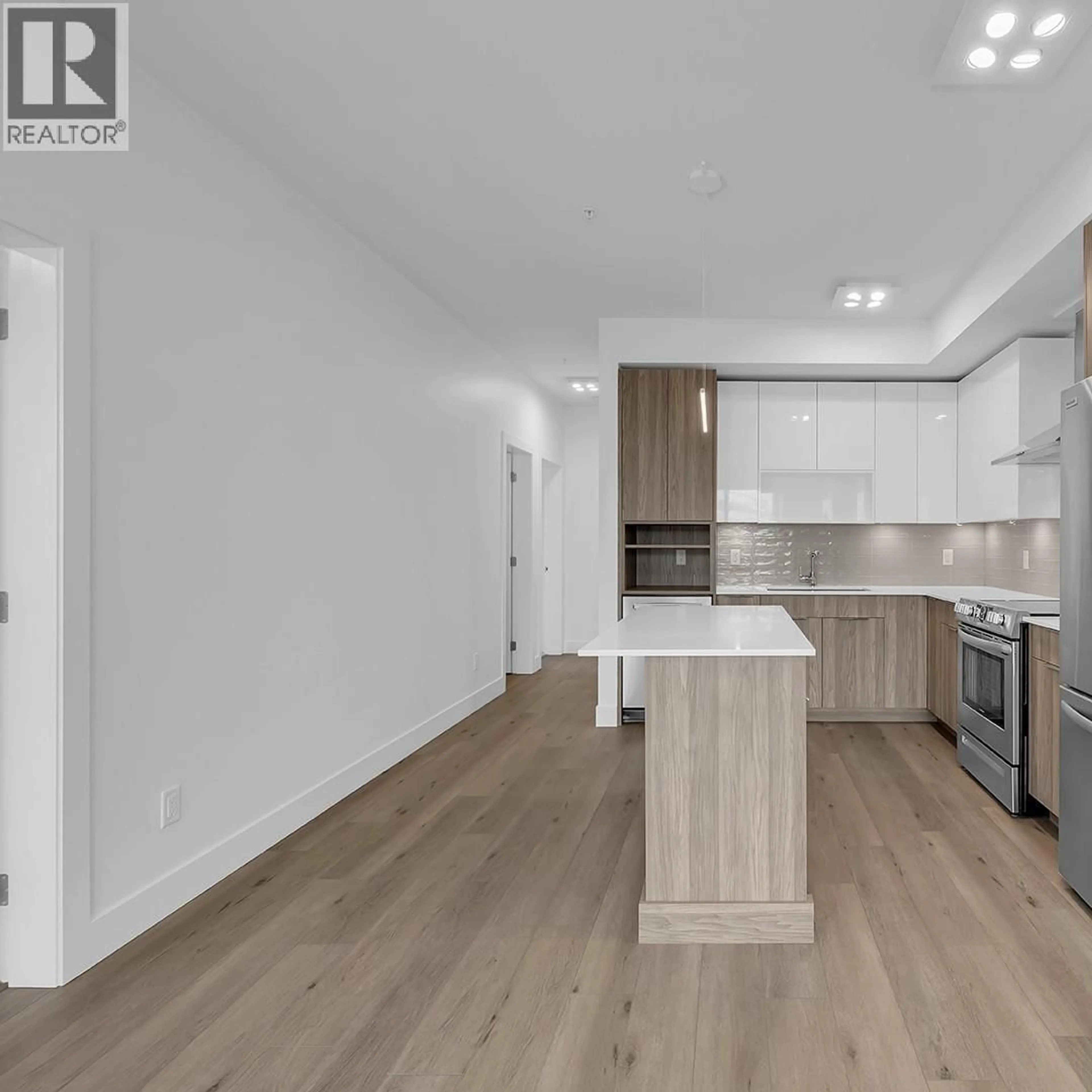 Open concept kitchen, wood/laminate floor for 502C - 3642 MISSION SPRINGS DRIVE, Kelowna British Columbia V1W0E1