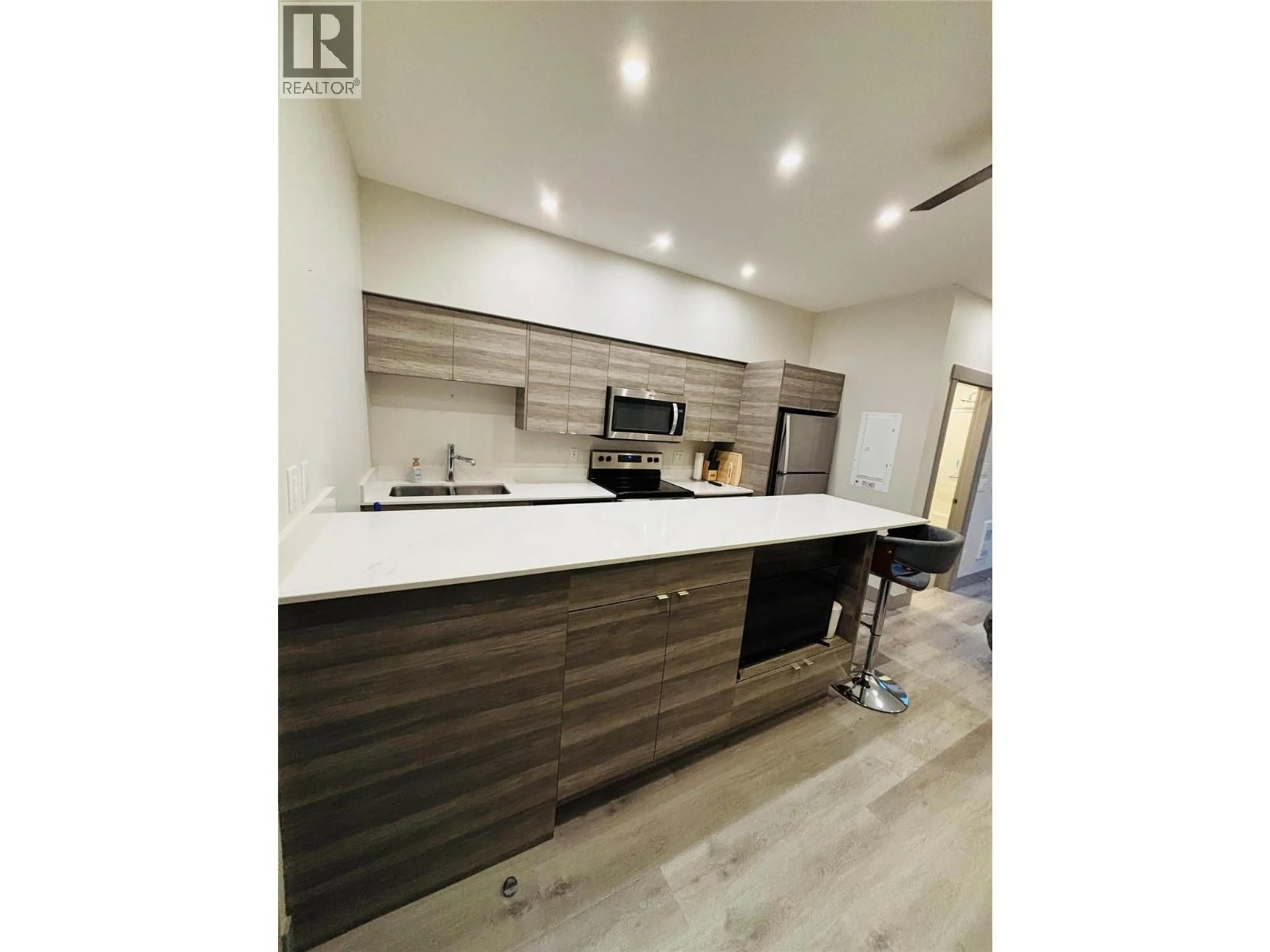 Open concept kitchen, wood/laminate floor for 507 - 2555 LAKESHORE ROAD, Vernon British Columbia V1H0A4