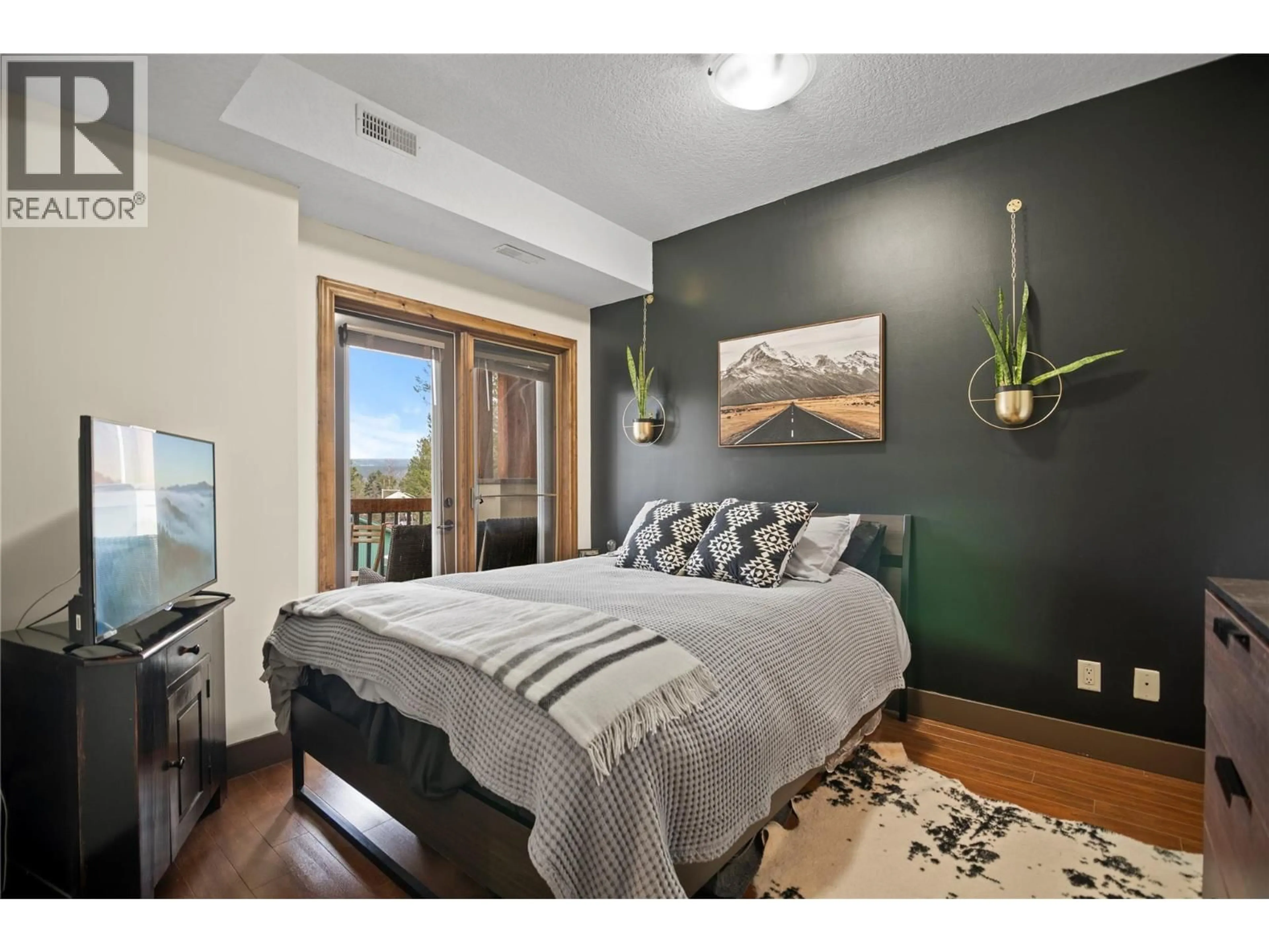 Bedroom with bed, wood/laminate floor for 2206 - 7495 COLUMBIA AVENUE, Radium Hot Springs British Columbia V0A1M0