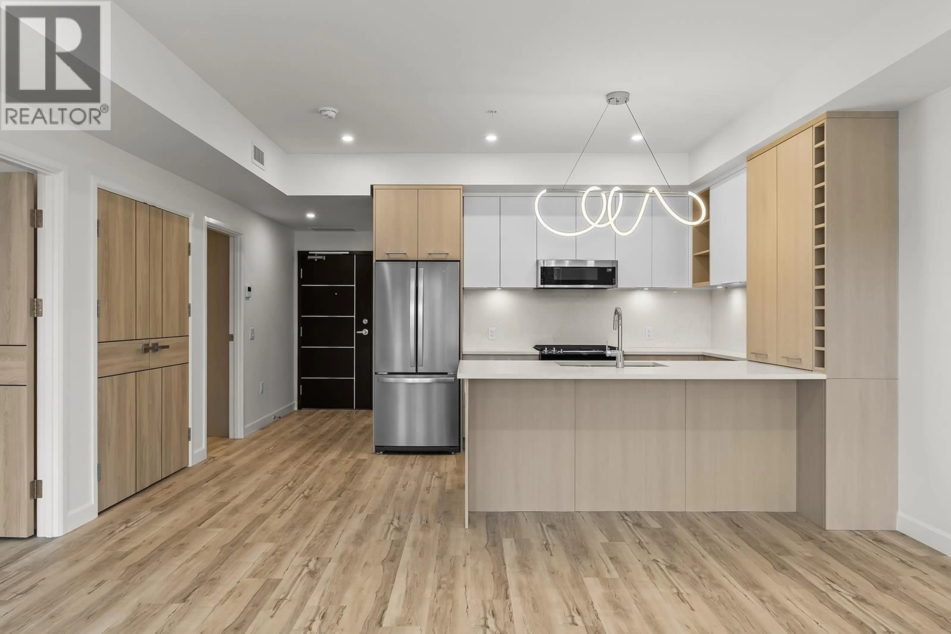 Open concept kitchen, wood/laminate floor for 311 - 630 BOYNTON PLACE, Kelowna British Columbia V1V3B8
