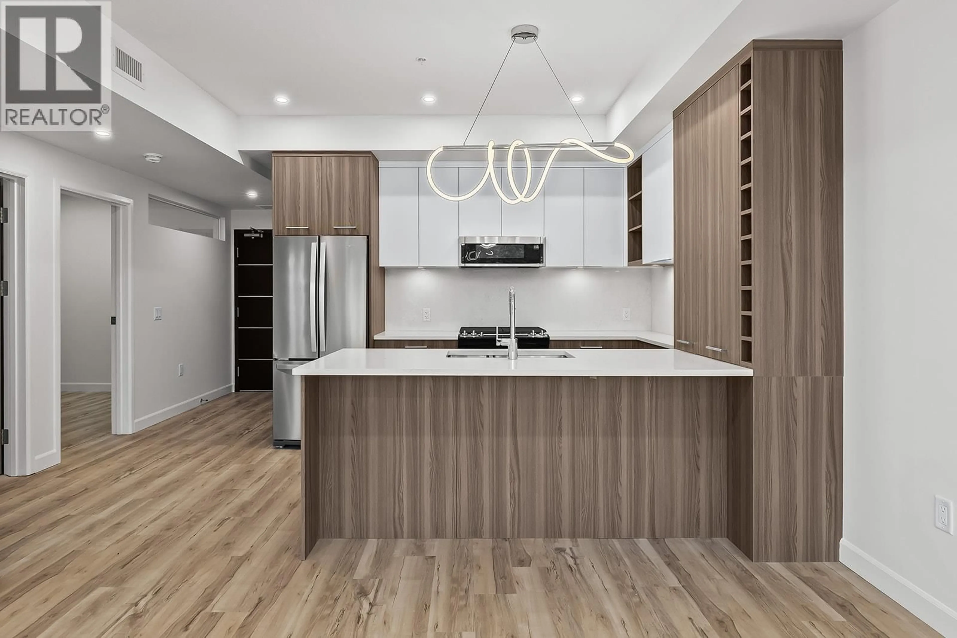 Open concept kitchen, wood/laminate floor for 305 - 630 BOYNTON PLACE, Kelowna British Columbia V1V3B8