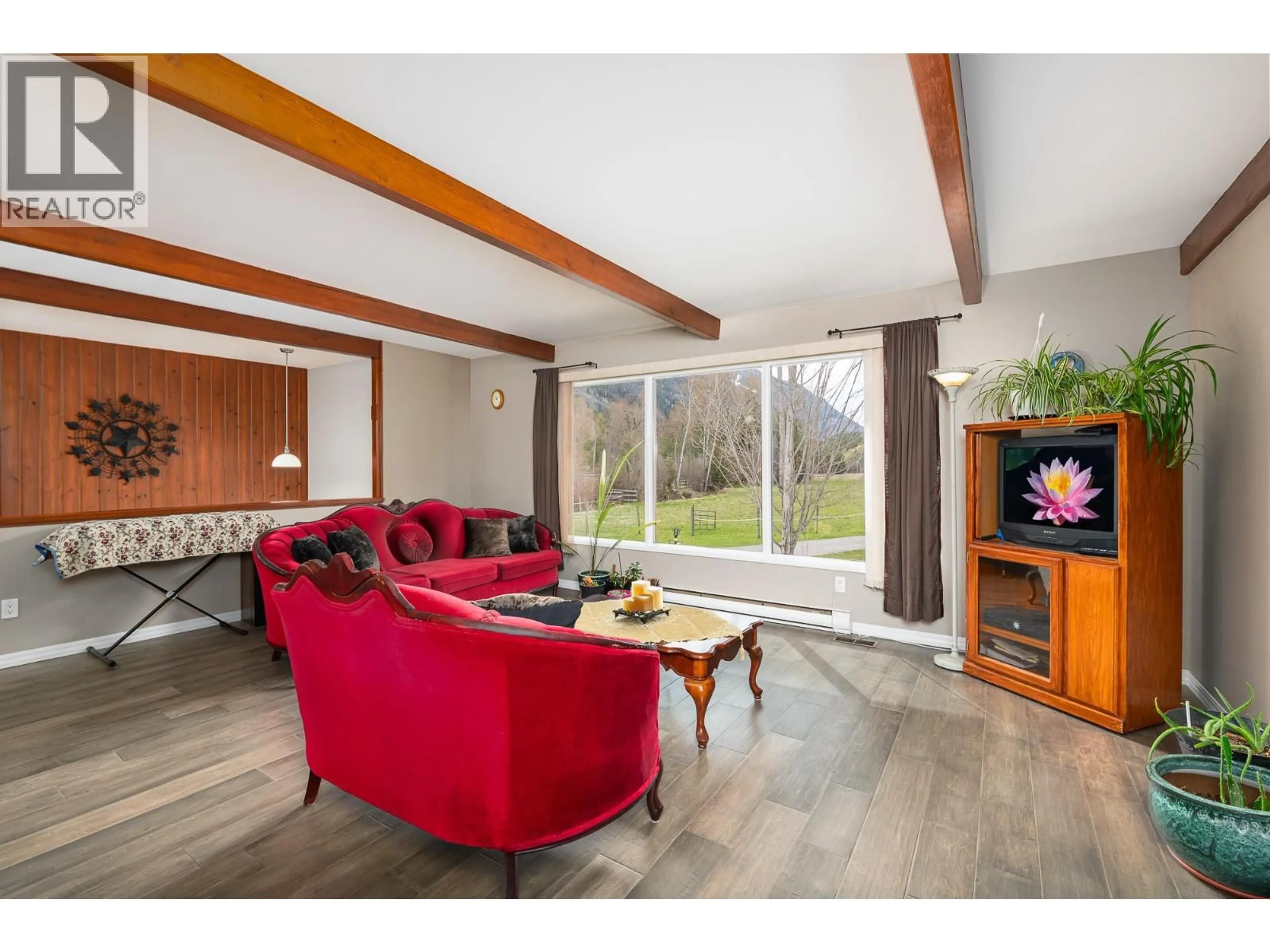 Living room with furniture, wood/laminate floor for 4856 32ND STREET, Canyon British Columbia V0B1C1