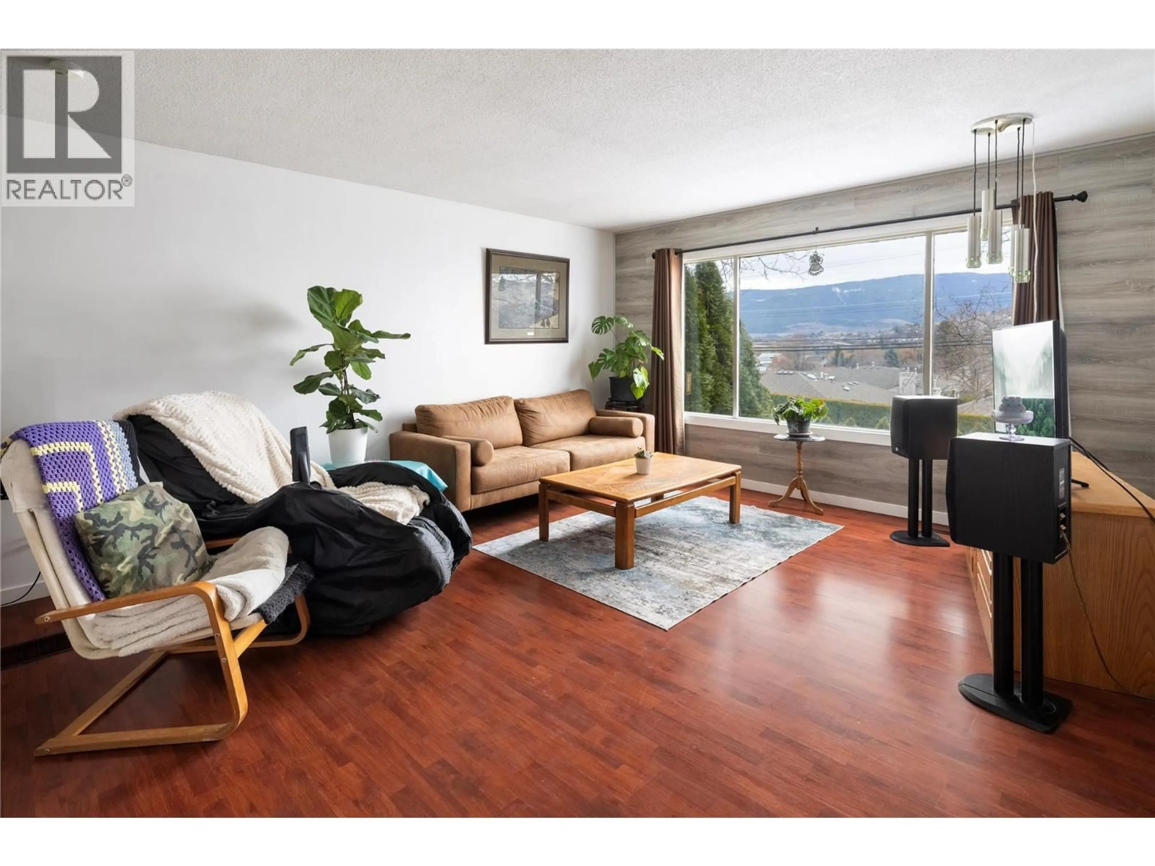 Living room with furniture, wood/laminate floor for 1203 25 AVENUE, Vernon British Columbia V1T7L5